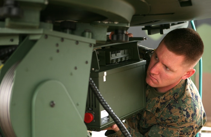 Sgt. Chris M. Bess, site manager for Support Wide Area Network and Wireless Point to Point Link training exercise, Communications Company, Combat Logistics Regiment 27, 2nd Marine Logistics Group, assembles the dish that connects the Master Reference Terminal to satellites, giving commanders vital internet, email and telephone capabilities.  The Marines of 2nd Communications Company, Combat Logistics Regiment 27, 2nd Marine Logistics Group trained with the systems Feb. 24, 2010 aboard Camp Lejeune, N.C., to train ensure proficiency with both systems.  (U.S. Marine Corps photo by Cpl. Meghan J. Canlas)