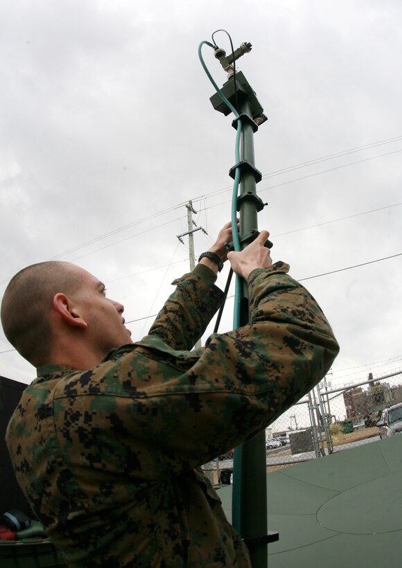 Cpl. Kenneth V. Holvenstot, an instructor for Support Wide Area Network and Wireless Point to Point Link training exercise, Communications Company, Combat Logistics Regiment 27, 2nd Marine Logistics Group, assembles the dish that connects the Master Reference Terminal to satellites, giving commanders vital internet, email and telephone capabilities.  The Marines of 2nd Communications Company, Combat Logistics Regiment 27, 2nd Marine Logistics Group trained with the systems Feb. 24, 2010 aboard Camp Lejeune, N.C., to train ensure proficiency with both systems.  (U.S. Marine Corps photo by Cpl. Meghan J. Canlas)