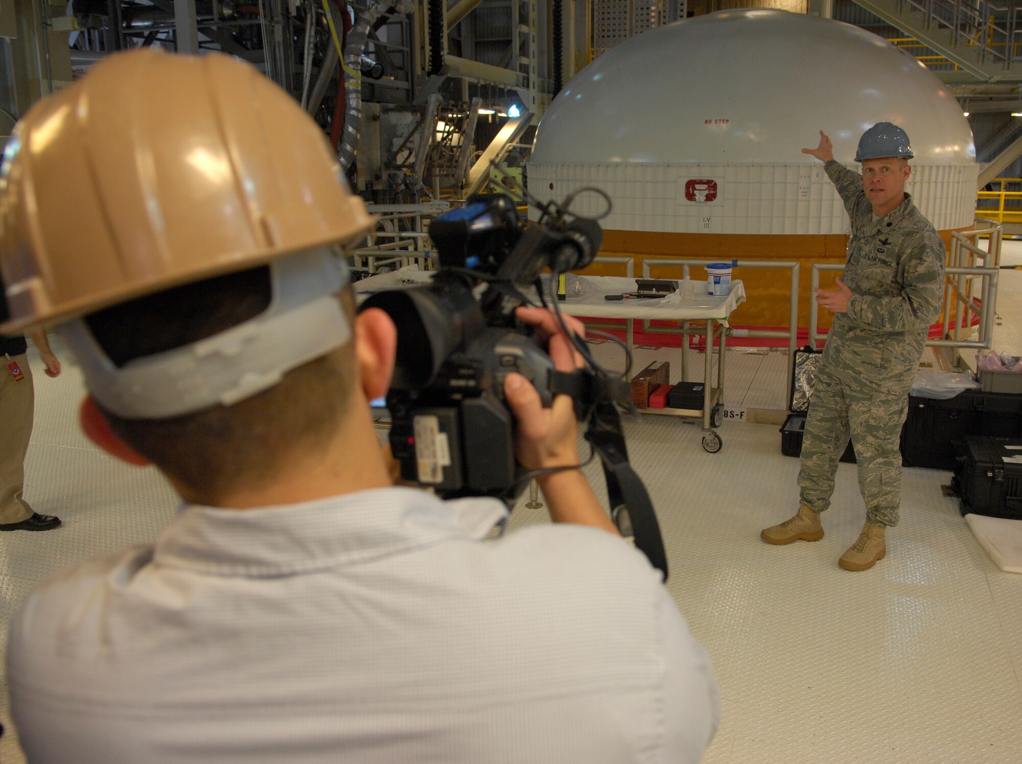 VANDENBERG AIR FORCE BASE, Calif. -- Lt. Col. Brady Hauboldt, the 4th Space Launch Squadron commander, talks to the media about the Delta IV Heavy, showing the tip of the rocket here Tuesday, Feb. 23, 2010. The Delta IV is scheduled to launch in December 2010. The Delta IV Heavy will be the largest rocket to ever launch from Vandenberg. (U.S. Air Force photo/Airman 1st Class Andrew Lee) 