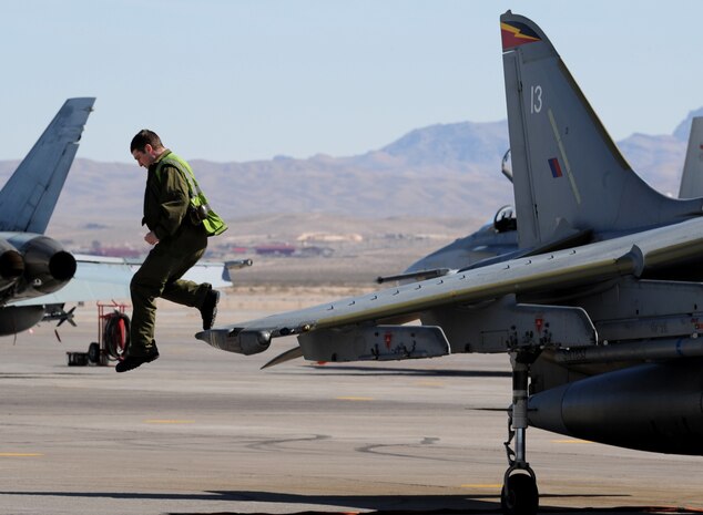 NELLIS AIR FORCE BASE, Nev. -- Senior Aircraftman Matt Green, 1st Fighter Squadron, crew chief from RAF Cottesmore, U.K. jumps from the wing of a GR-9 Harrier before a training mission at Red Flag 10-3 Feb. 23, 2010.  Red Flag is a realistic combat training exercise involving the air forces of the United States and its allies. The exercise is conducted on the 15,000-square-mile Nevada Test and Training Range, north of Las Vegas. (U.S. Air Force photo by Airman 1st Class Brett Clashman/RELEASED)