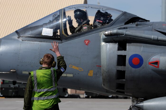NELLIS AIR FORCE BASE, Nev. -- Flight Officer Deavin, 1st Fighter Squadron, pilot from RAF Cottesmore, U.K. waves to Senior Aircraftsman Sam Ash at Red Flag 10-3 Feb. 23, 2010.  Red Flag is a realistic combat training exercise involving the air forces of the United States and its allies. The exercise is conducted on the 15,000-square-mile Nevada Test and Training Range, north of Las Vegas. (U.S. Air Force photo by Airman 1st Class Brett Clashman/RELEASED)