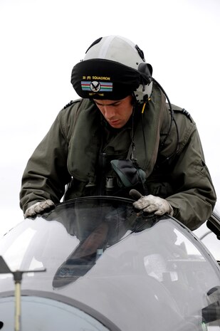 NELLIS AIR FORCE BASE, Nev. -- Flight Lieutenant Nick Lane, A pilot from RAF Cottesmore, U.K. positions himself inside a GR-9 Harrier before a training mission at Red Flag 10-3 Feb. 23, 2010. Red Flag is a realistic combat training exercise involving the air forces of the United States and its allies. The exercise is conducted on the 15,000-square-mile Nevada Test and Training Range, north of Las Vegas. (U.S. Air Force photo by Airman 1st Class Brett Clashman/RELEASED)