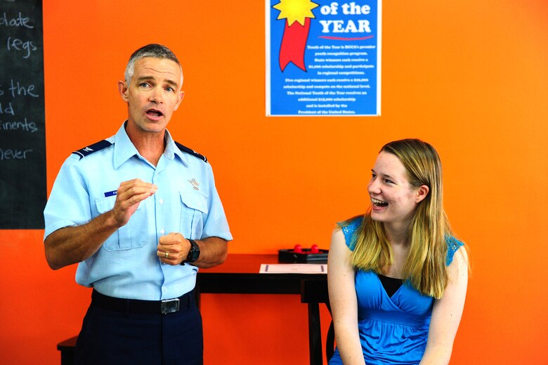 Ashley Nelson, daughter of Master Sgt. Dennis Nelson, 36th Civil Engineer Squadron, reacts with surprise when Col. Tod Fingal, 36th Wing vice commander, tells her she has won an Air Force writing contest. The contest was sponsored by MyAirForceLife.com and the $2,000 prize package includes a new computer and $500 gift card. (U.S. Air Force photo by Tech. Sgt. Mike Andriacco)