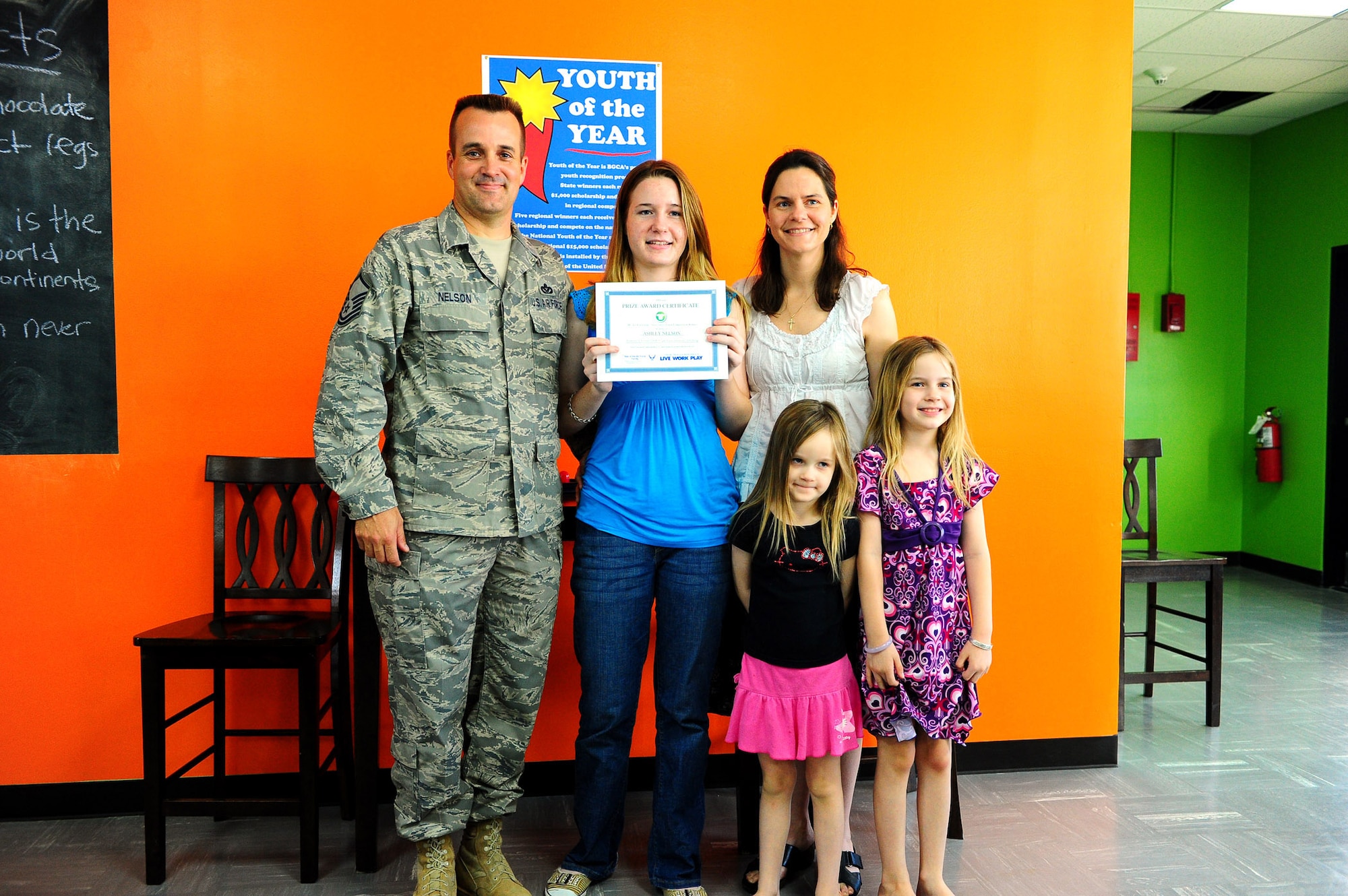 Ashley Nelson, daughter of Master Sgt. Dennis Nelson, 36th Civil Engineer Squadron, poses with her family after winning an Air Force writing contest. The contest was sponsored by MyAirForceLife.com and the $2,000 prize package includes a new computer and $500 gift card. (U.S. Air Force photo by Tech. Sgt. Mike Andriacco)