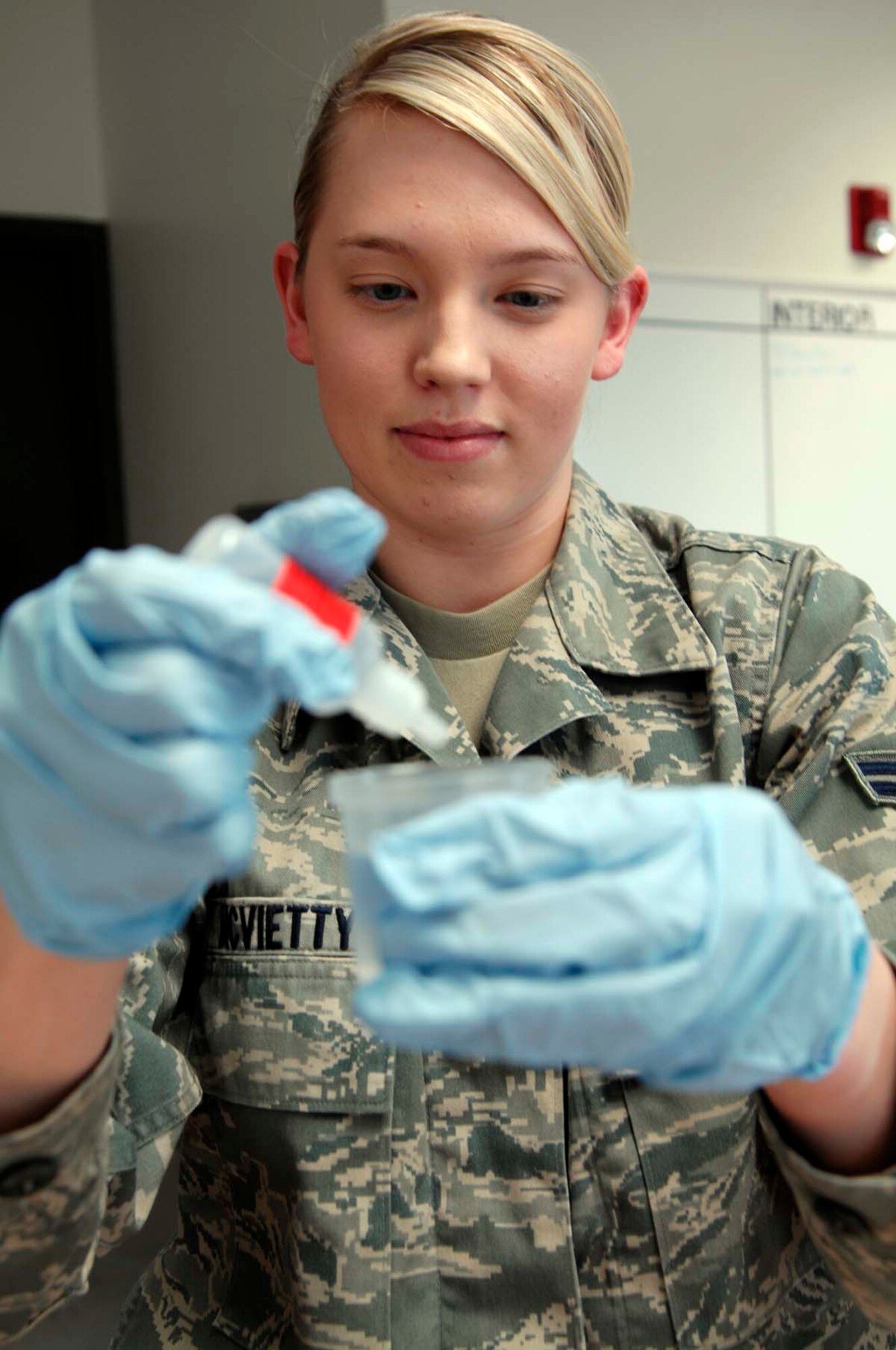 Airman 1st Class Kayla McVietty, 22nd Aerospace Medicine Squadron Bioenvironmental Engineering flight journeyman, tests a sample of McConnell’s water supply for PH levels, chlorine and conductivity.  The Geneseo, Ill., native also provides occupational health assessments, manages the respiratory protection program, and also performs gas mask fit tests at McConnell. (U.S. Air Force photo by/Senior Airman Abigail Klein)