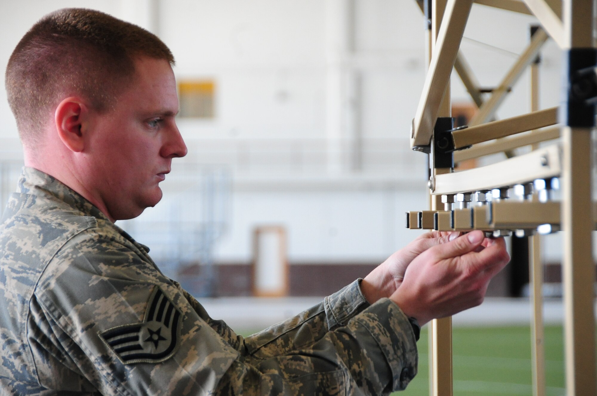 ELLSWORTH AIR FORCE BASE, S.D. -- Staff Sgt. Damian Rennells, 28th Logistics Readiness Squadron mobile hydrant supervisor, constructs decontamination racks in preparation, Feb. 24, for the upcoming Phase II Operational Readiness Exercise.  The Phase II ORE will test Airmen across the base on their readiness in a deployed environment. (U.S. Air Force photo/Airman 1st Class Anthony Sanchelli)
