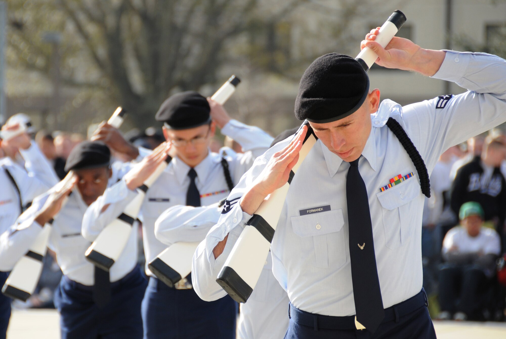 From left, Airman Kevin Bacon, Airman Basic Tom Phan and Airman 1st Class Joshua Formanek salute during the 336th TRS freestyle performance.  (U.S. Air Force photo by Kemberly Groue)