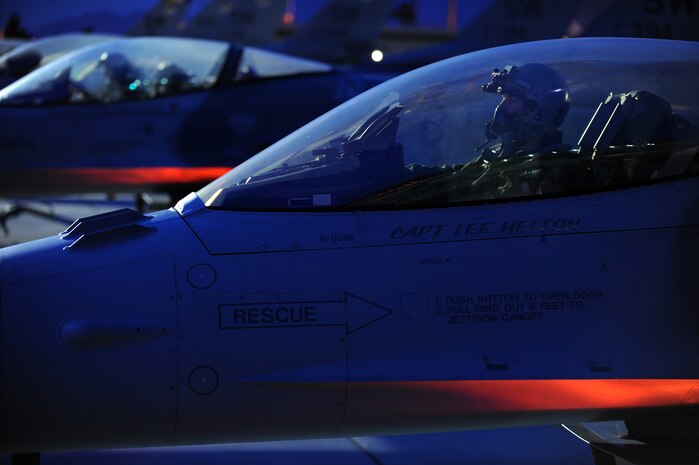 NELLIS AIR FORCE BASE, Nev. -- A 55th Fighter Squadron, pilot from Shaw AFB, S.C. completes pre-flight checks in an F-16 before a night training mission at Red Flag 10-3 Feb. 23, 2010.  Red Flag is a realistic combat training exercise involving the air forces of the United States and its allies. The exercise is conducted on the 15,000-square-mile Nevada Test and Training Range, north of Las Vegas. (U.S. Air Force photo by Tech. Sgt. Michael R. Holzworth/RELEASED)
