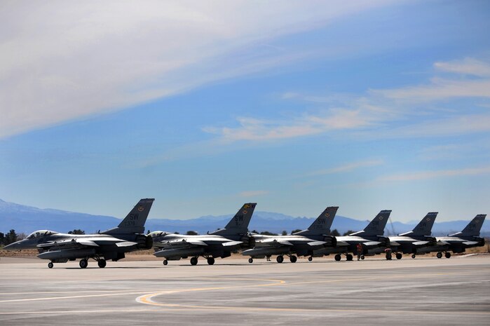 NELLIS AIR FORCE BASE, Nev. -- 55th Fighter Squadron, F-16's from Shaw AFB, S.C. sit at the end of the runway and await clearance for take off during Red Flag 10-3 Feb. 23, 2010.  Red Flag is a realistic combat training exercise involving the air forces of the United States and its allies. The exercise is conducted on the 15,000-square-mile Nevada Test and Training Range, north of Las Vegas. (U.S. Air Force photo by Tech. Sgt. Michael R. Holzworth/RELEASED)