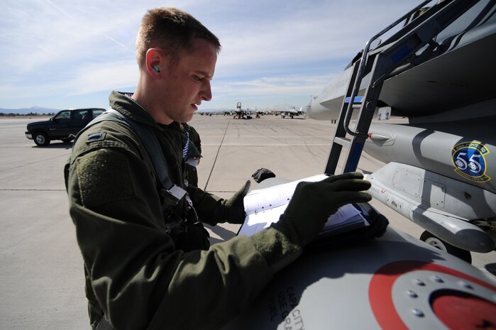 NELLIS AIR FORCE BASE, Nev. -- Airman 1st Class Joshua Koch 20th Aircraft Maintenance Squadron, crew chief from Shaw AFB, S.C. helps 1st Lt. Greg Farrell  55th Fighter Squadron, pilot get strapped into his F-16 at Red Flag 10-3 Feb. 23, 2010.  Red Flag is a realistic combat training exercise involving the air forces of the United States and its allies. The exercise is conducted on the 15,000-square-mile Nevada Test and Training Range, north of Las Vegas. (U.S. Air Force photo by Tech. Sgt. Michael R. Holzworth/RELEASED)