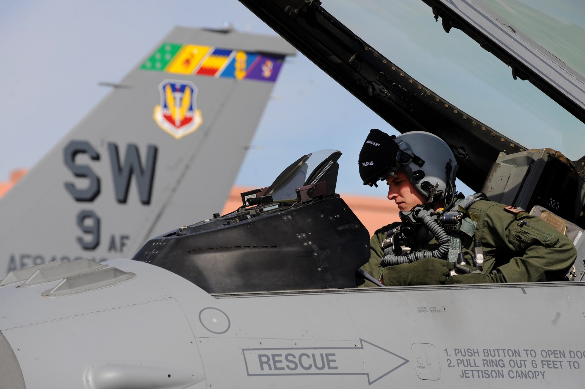 NELLIS AIR FORCE BASE, Nev. -- 1st Lt. Greg Farrell a 55th Fighter Squadron, pilot from Shaw AFB, S.C. get strapped into anF-16 before departing on a training mission at Red Flag 10-3 Feb. 23, 2010.  Red Flag is a realistic combat training exercise involving the air forces of the United States and its allies. The exercise is conducted on the 15,000-square-mile Nevada Test and Training Range, north of Las Vegas. (U.S. Air Force photo by Tech. Sgt. Michael R. Holzworth/RELEASED)