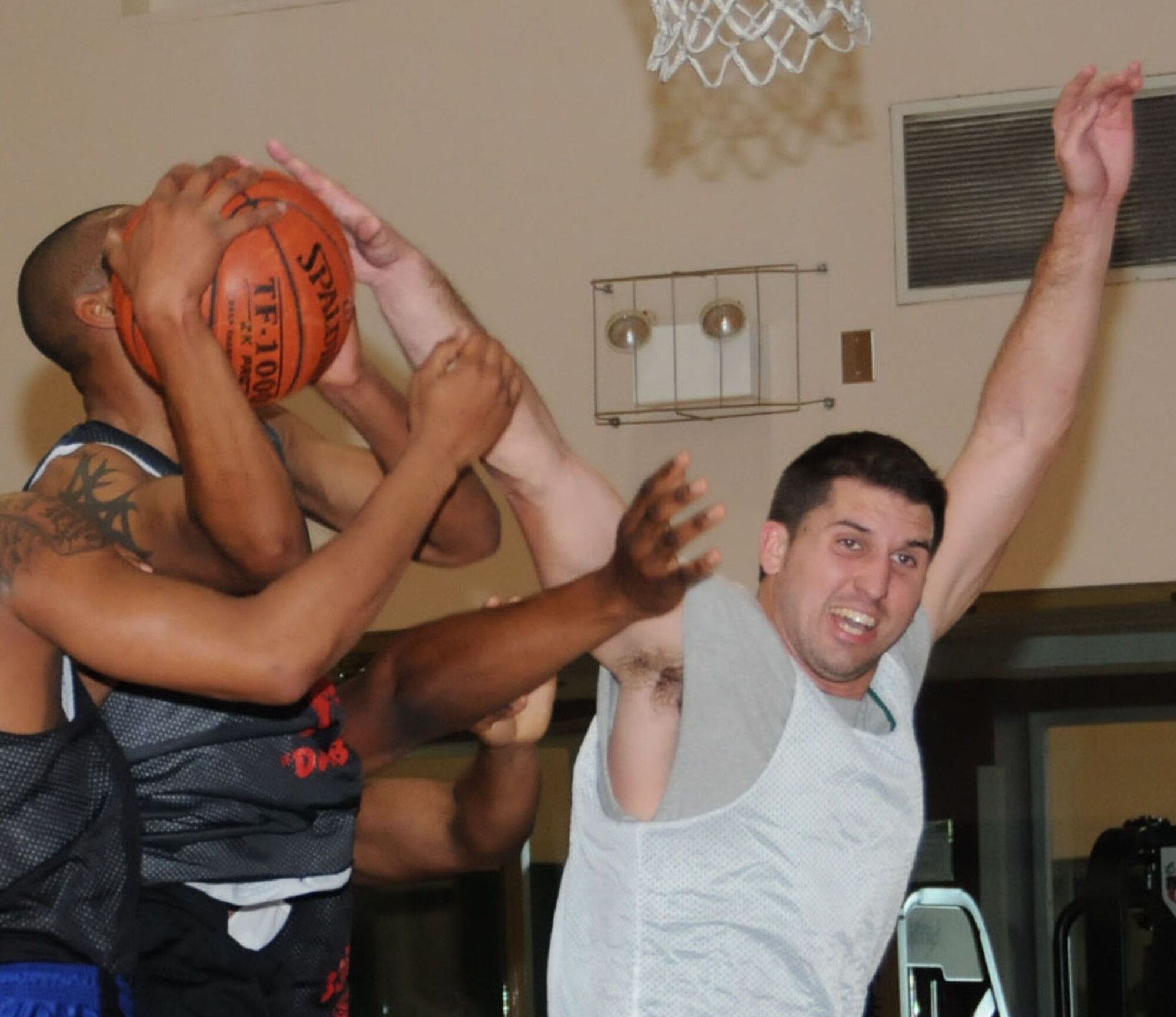 Darius Sutton, left, 335th TRS, tries to make a shot in the paint that was deflected by Ryan Rice, 81st FSS-CPTS.  (U.S. Air Force photo by Kemberly Groue)
