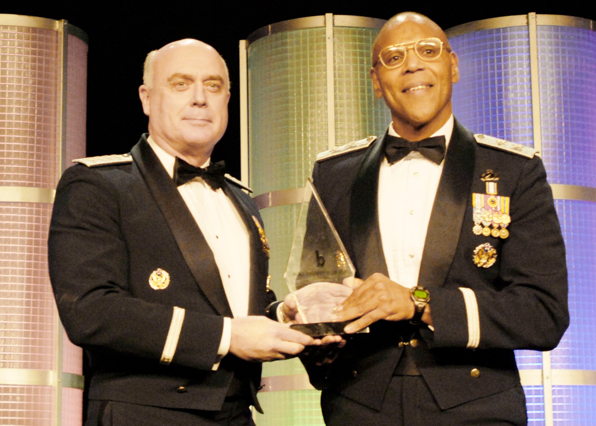 Air Force Vice Chief of Staff Gen. Carrol H "Howie" Chandler (left) presents the Career Achievement in Government award to Maj. Gen. Larry Spencer Feb. 20, 2010, at the Black Engineer of the Year Awards conference in Baltimore.  The BEYA conference awards recognize those with exceptional career gains in various vocations in science, technology, engineering and mathematics career fields.  General Spencer was recently confirmed for promotion as well as a position on the Joint Staff.  (U.S. Air Force photo/Staff Sgt. J.G. Buzanowski)