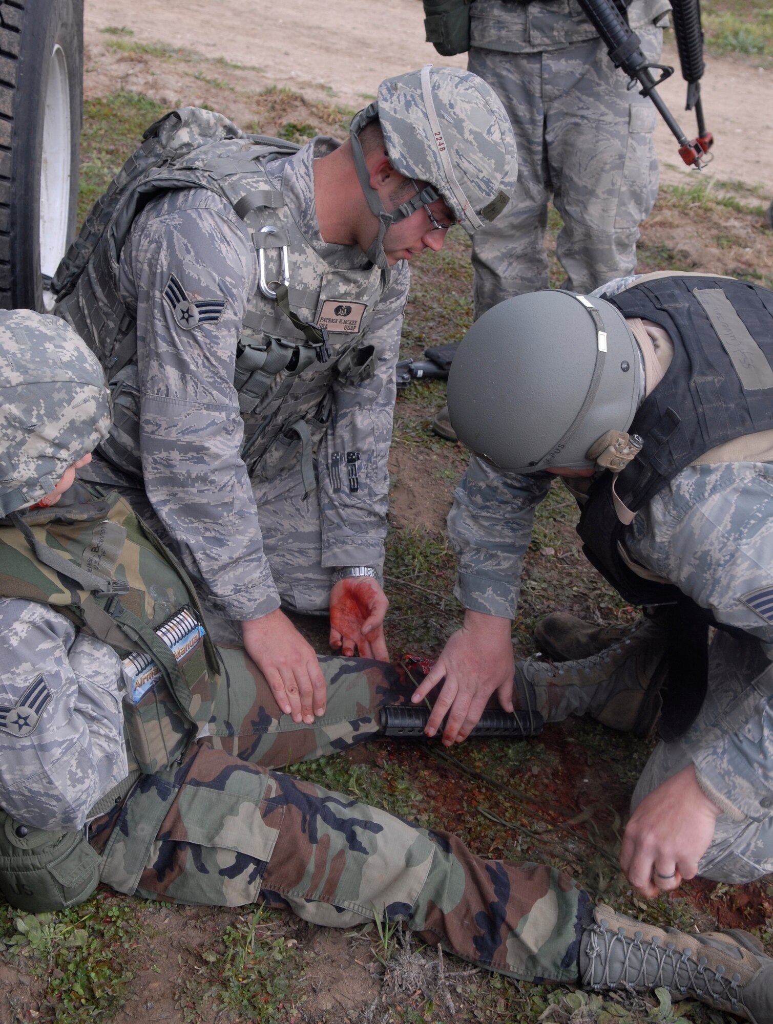 VANDENBERG AIR FORCE BASE, Calif. -- Using M-16 hand guards, Senior Airman Patrick McKee and Staff Sgt. Jason Culverson splint Senior Airman Melissa Brannon's injured leg during a North Star exercise here Friday, Feb. 19, 2010. On the last day of North Star, Airmen are put to the final test during multiple scenarios that evaluate all aspects of deployment readiness. (U.S. Air Force photo/Senior Airman Ashley Reed)