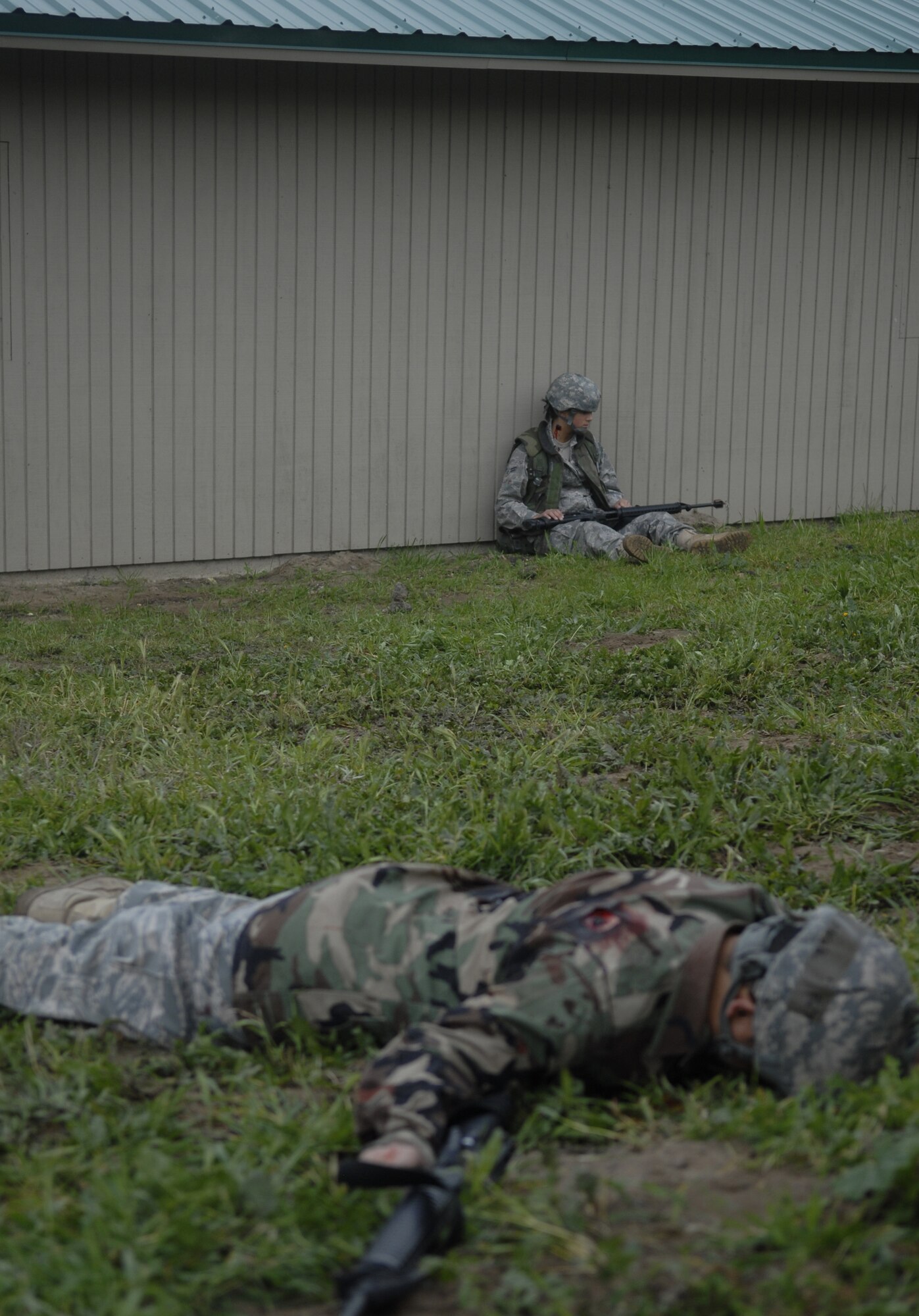 VANDENBERG AIR FORCE BASE, Calif. -- Awaiting help, two injured Airmen test their teammates’ self-aid and buddy care abilities at the North Star exercise site here Friday, Feb. 19, 2010. In this scenario, multiple Airmen were injured after the base was attacked and teammates had to provide SABC while securing the base. (U.S. Air Force photo/Senior Airman Ashley Reed)