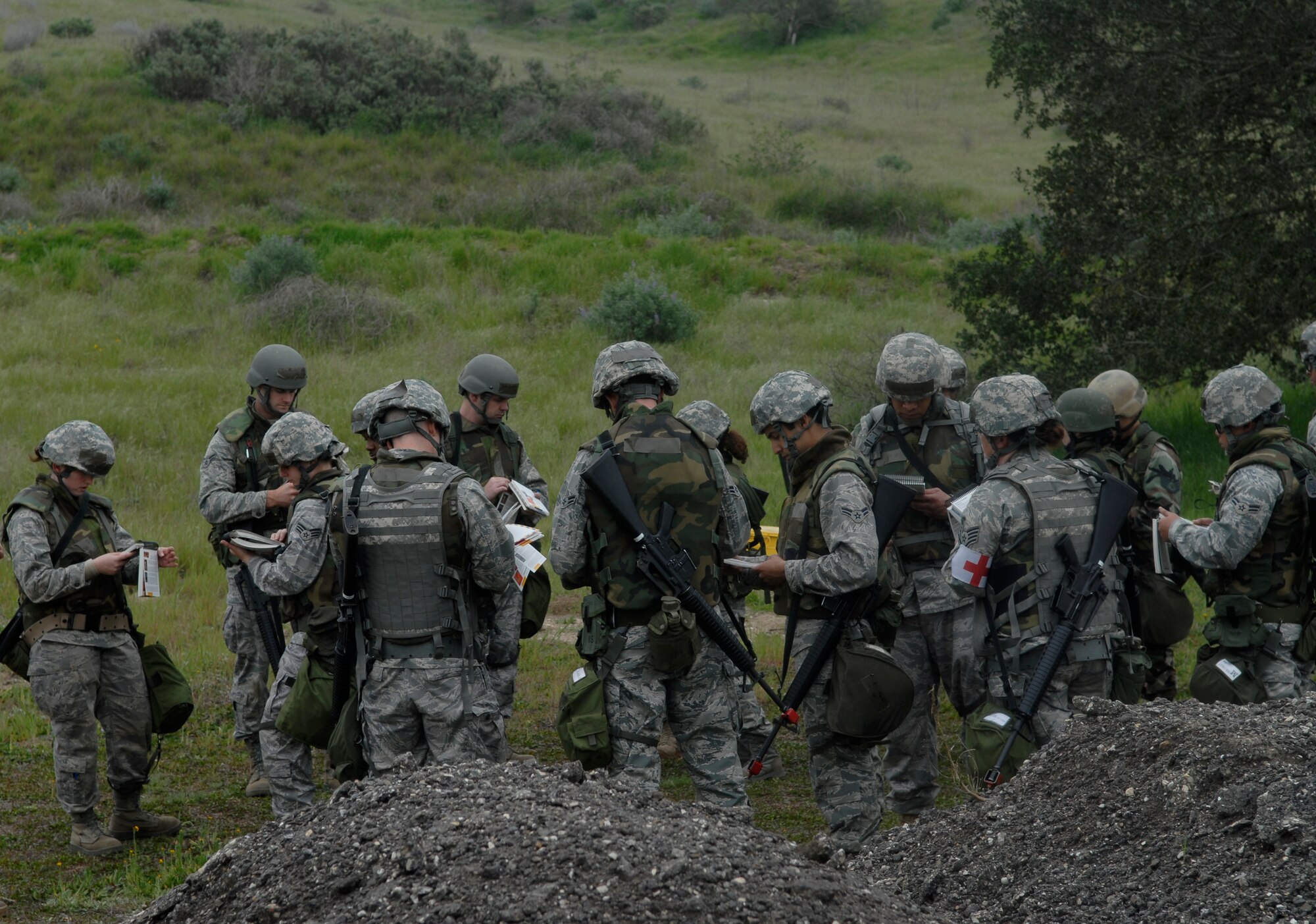 VANDENBERG AIR FORCE BASE, Calif. -- Looking through Airman's Manuals, members of Team Vandenberg prepare for an unexploded ordnance sweep at the North Star exercise here Thursday, Feb. 18, 2010. North Star is an exercise that helps Vandenberg Airmen prepare for deployment taskings. (U.S. Air Force photo/Senior Airman Ashley Reed)