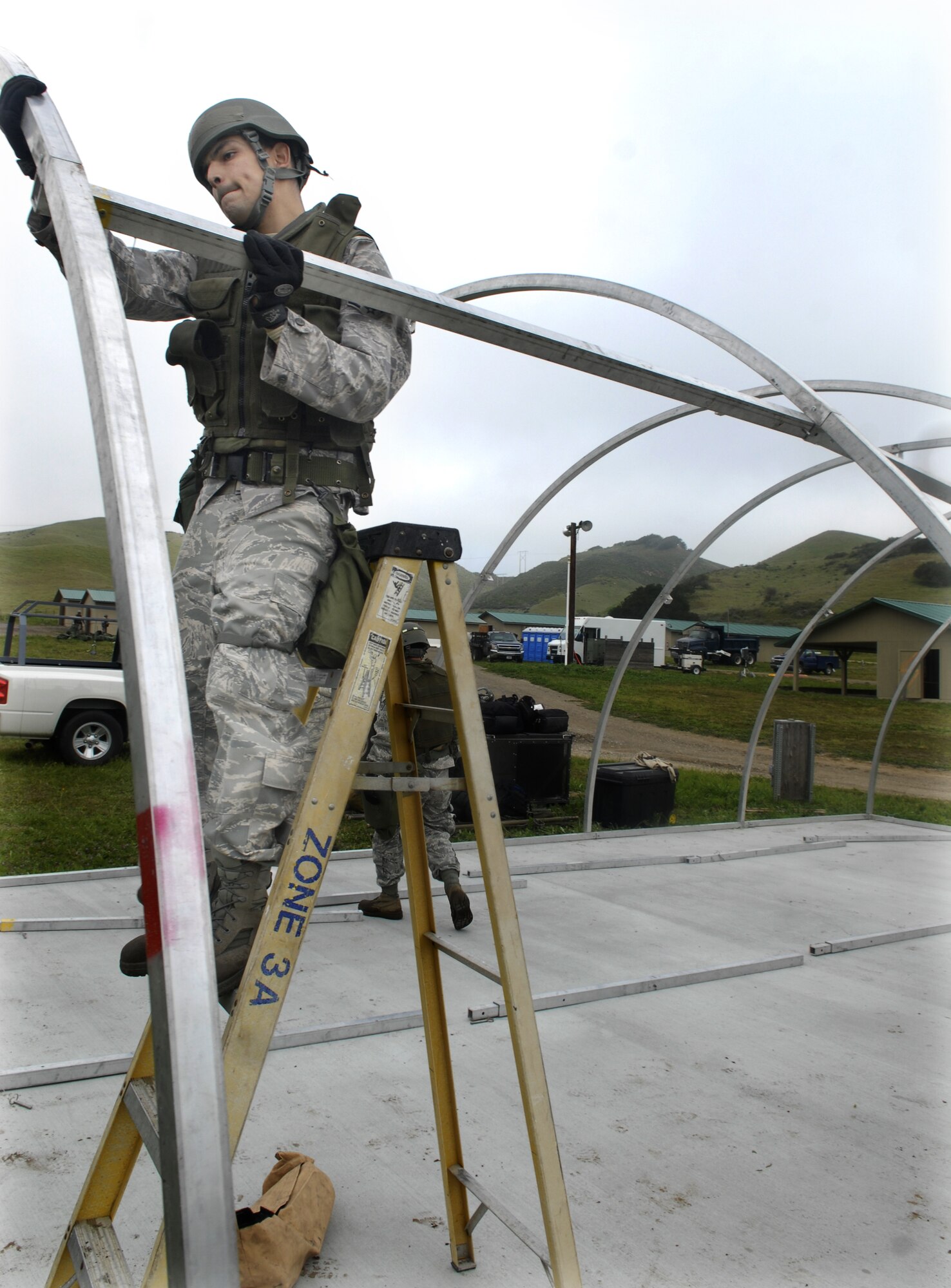 VANDENBERG AIR FORCE BASE, Calif. -- Connecting the posts, Senior Airman Miguel Tarango helps set up a medical tent at the North Star exercise here Thursday, Feb. 18, 2010. Airman Tarango, part of the 30th Civil Engineer Squadron, set up the only tent utilized during the North Star exercise. (U.S. Air Force photo/Senior Airman Ashley Reed)