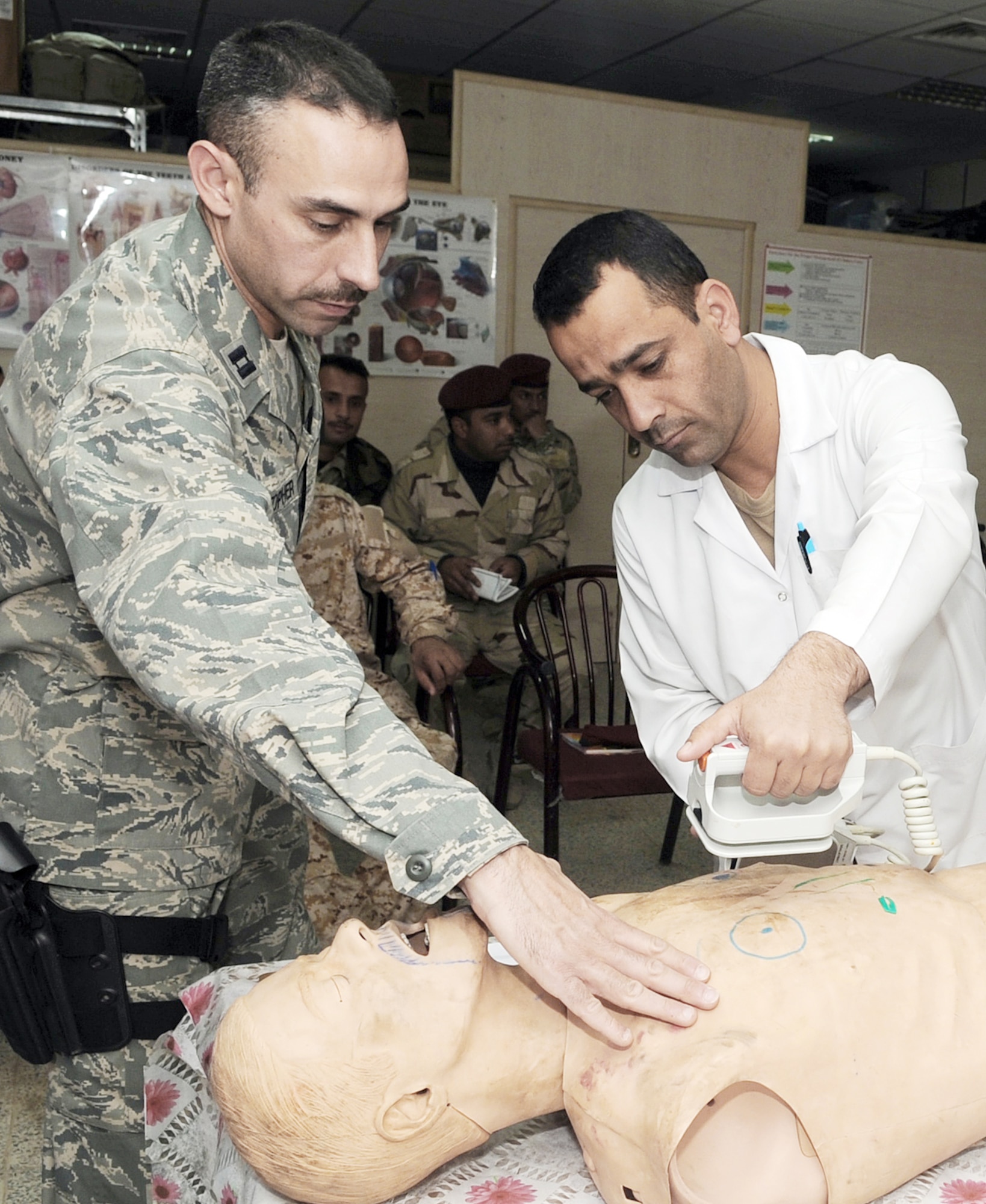 Capt. Adam Christopher and Staff Sgt. Andrew Salas teach Iraqi medics how to use a defibrillator Feb. 16, 2010, at Kirkuk Air Base, Iraq. This training is part of the Expert Field Medical Batch four-week course offered to Iraqi medics at the K-1 Iraqi medical clinic in order to provide the experience they will need in real-world situations. Captain Christopher and Sergeant Salas are assigned to the 506th Expeditionary Medical Squadron. (U.S. Air Force photo/Staff Sgt. Tabitha Kuykendall)
