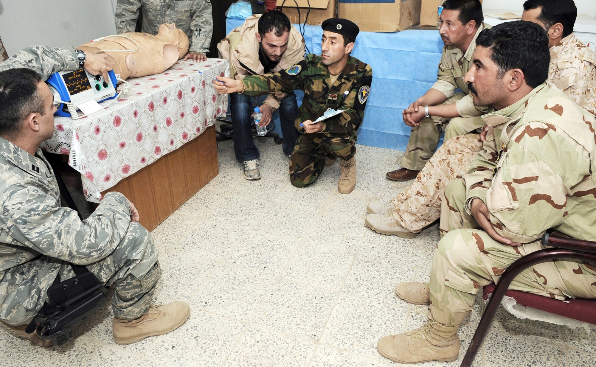 Capt. Adam Christopher and Staff Sgt. Andrew Salas teach Iraqi medics how to use a defibrillator Feb. 16, 2010, at Kirkuk Air Base, Iraq. This training is part of the Expert Field Medical Batch four-week course offered to Iraqi medics at the K-1 Iraqi medical clinic in order to provide the experience they will need in real-world situations. Captain Christopher and Sergeant Salas are assigned to the 506th Expeditionary Medical Squadron. (U.S. Air Force photo/Staff Sgt. Tabitha Kuykendall)