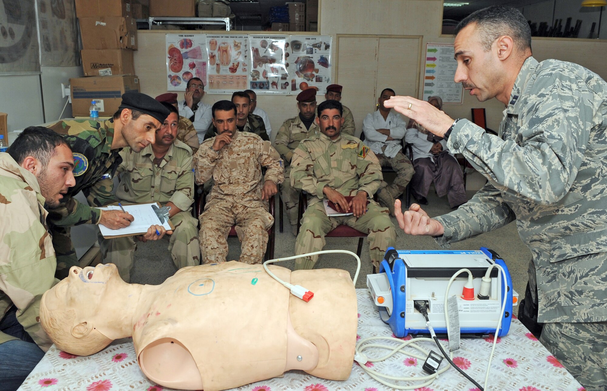 Capt. Adam Christopher and Staff Sgt. Andrew Salas teach Iraqi medics how to use a defibrillator Feb. 16, 2010, at Kirkuk Air Base, Iraq. This training is part of the Expert Field Medical Batch four-week course offered to Iraqi medics at the K-1 Iraqi medical clinic in order to provide the experience they will need in real-world situations. Captain Christopher and Sergeant Salas are assigned to the 506th Expeditionary Medical Squadron. (U.S. Air Force photo/Staff Sgt. Tabitha Kuykendall)