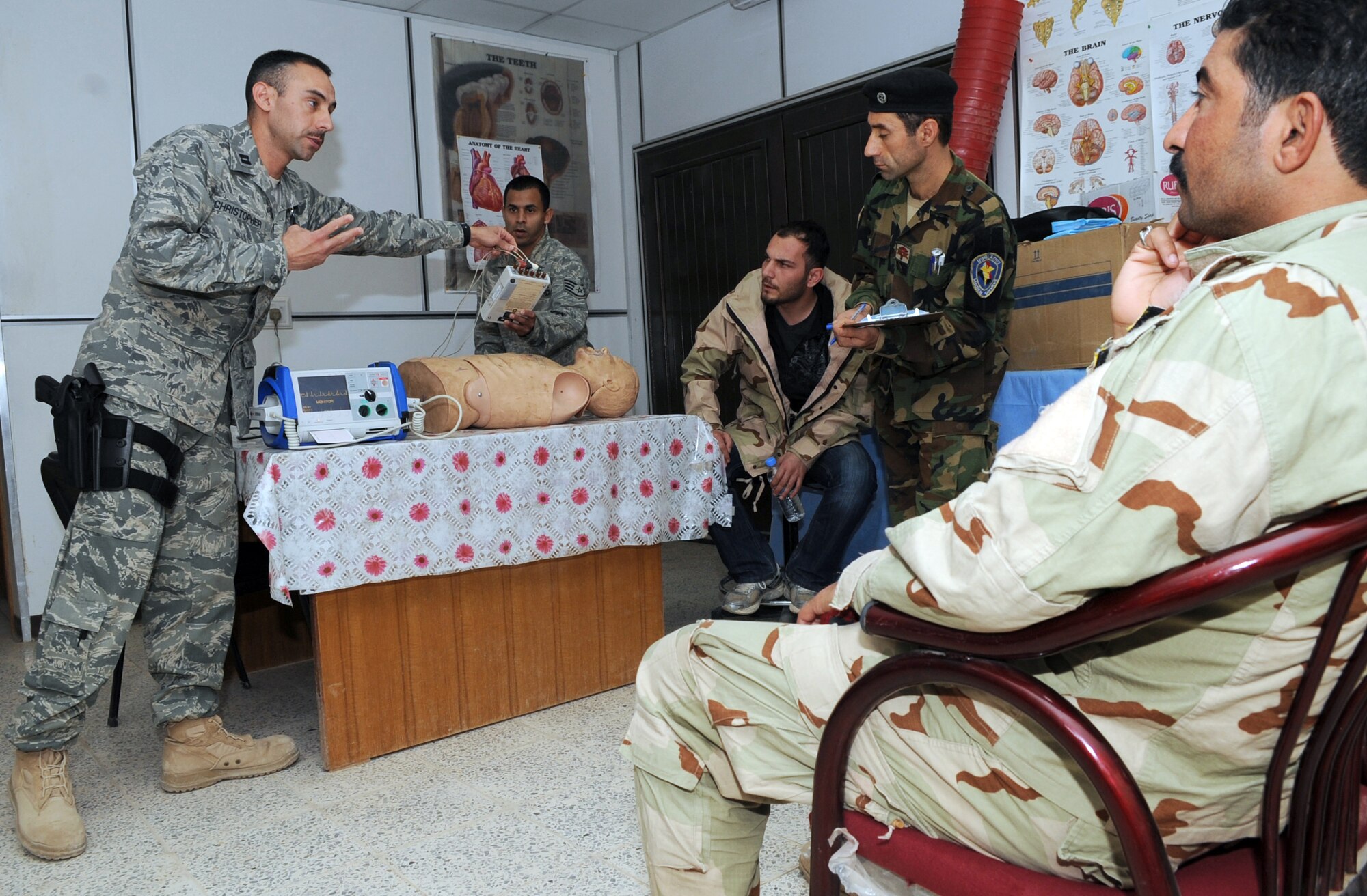 Capt. Adam Christopher and Staff Sgt. Andrew Salas teach Iraqi medics how to use a defibrillator Feb. 16, 2010, at Kirkuk Air Base, Iraq. This training is part of the Expert Field Medical Batch four-week course offered to Iraqi medics at the K-1 Iraqi medical clinic in order to provide the experience they will need in real-world situations. Captain Christopher and Sergeant Salas are assigned to the 506th Expeditionary Medical Squadron. (U.S. Air Force photo/Staff Sgt. Tabitha Kuykendall)