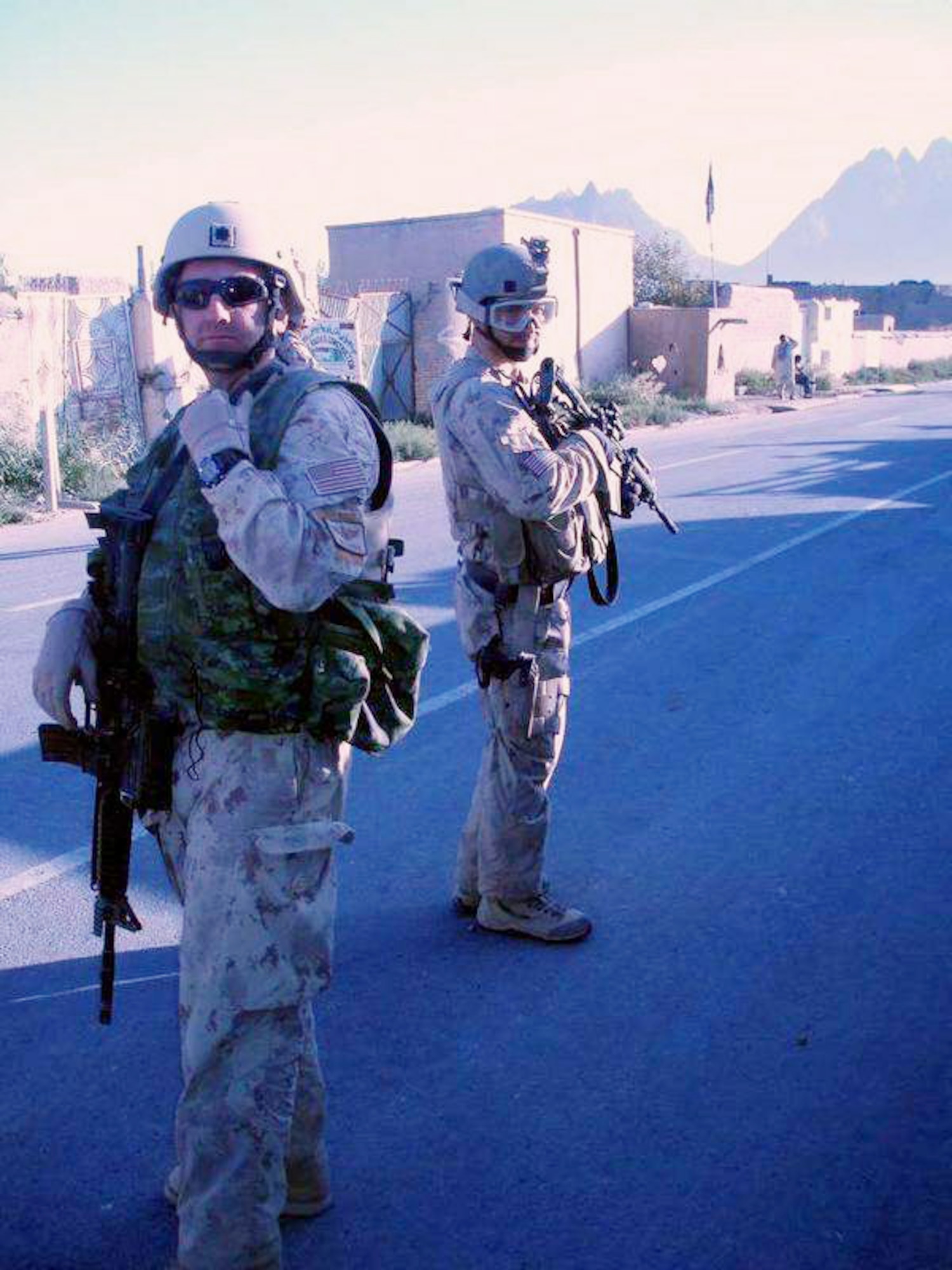 Lt. Col. Greg Harbin (left) patrols a village in Afghanistan while embedded with Canadian forces near Kandahar, Afghanistan. A bullet struck from behind but did not penetrate Colonel Harbin's body armor 10 minutes after the photo was taken. Trained and equipped with remotely operated video enhanced receiver or ROVER, Air Force ground combat teams work with assigned ground units. ROVERs heighten the effectiveness of and mitigate collateral damage by allowing ground troops to "see" what the aircrew sees with unmanned aircraft and fighter or bomber aircraft. (Courtesy photo)
