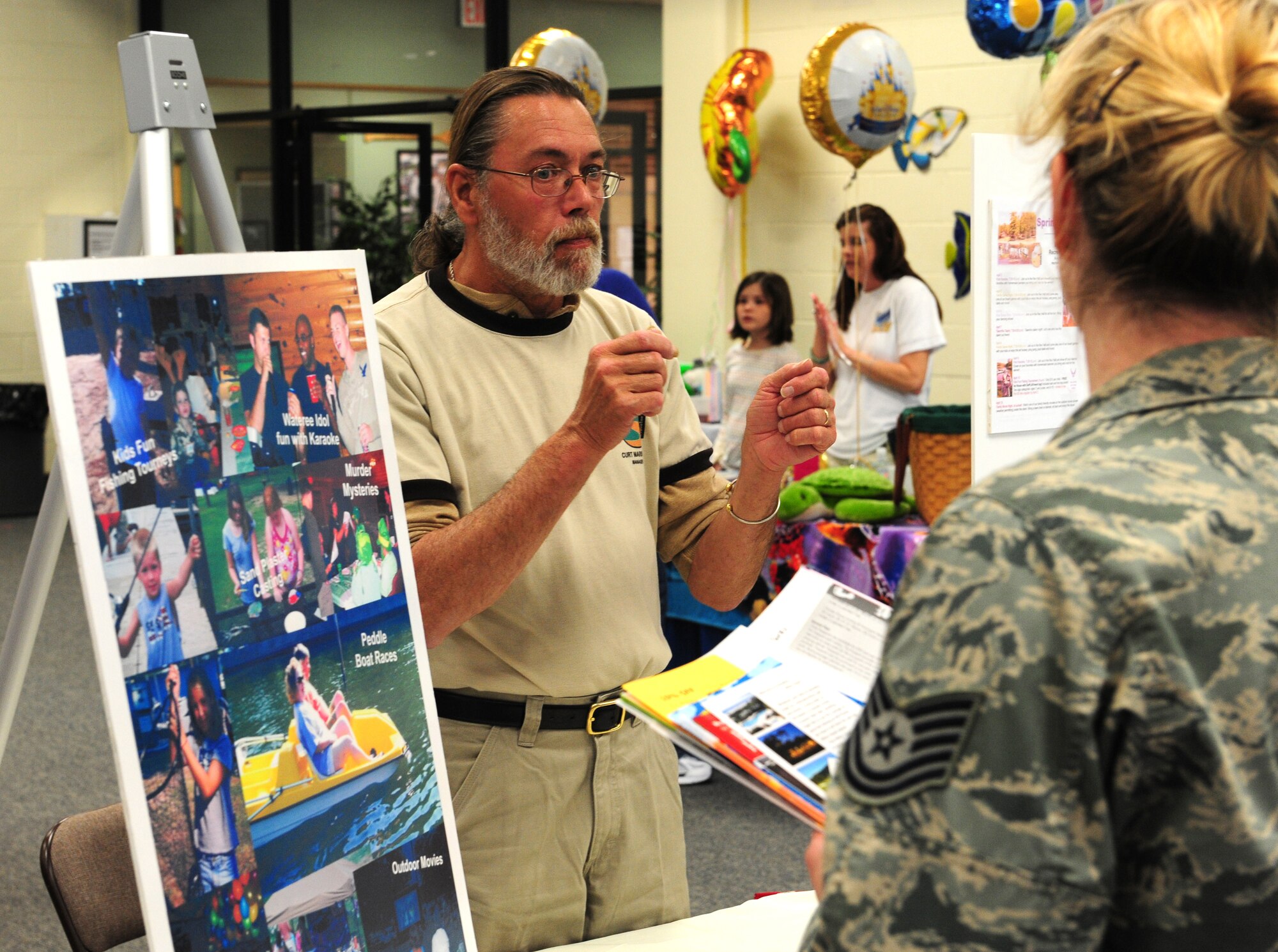 SHAW AIR BASE -- Curt Marshall, the manager for Shaw's Lake Wateree recreation area, explains the rec area to a non-commissioned officer at the travel fair here Feb. 23. The Information, Tickets and Tours-sponsored travel fair was designed to allow Team Shaw the opportunity to get information directly from suppliers about regional recreation opportunities. (U.S. Air Force photo/Airman 1st Class Daniel Phelps)