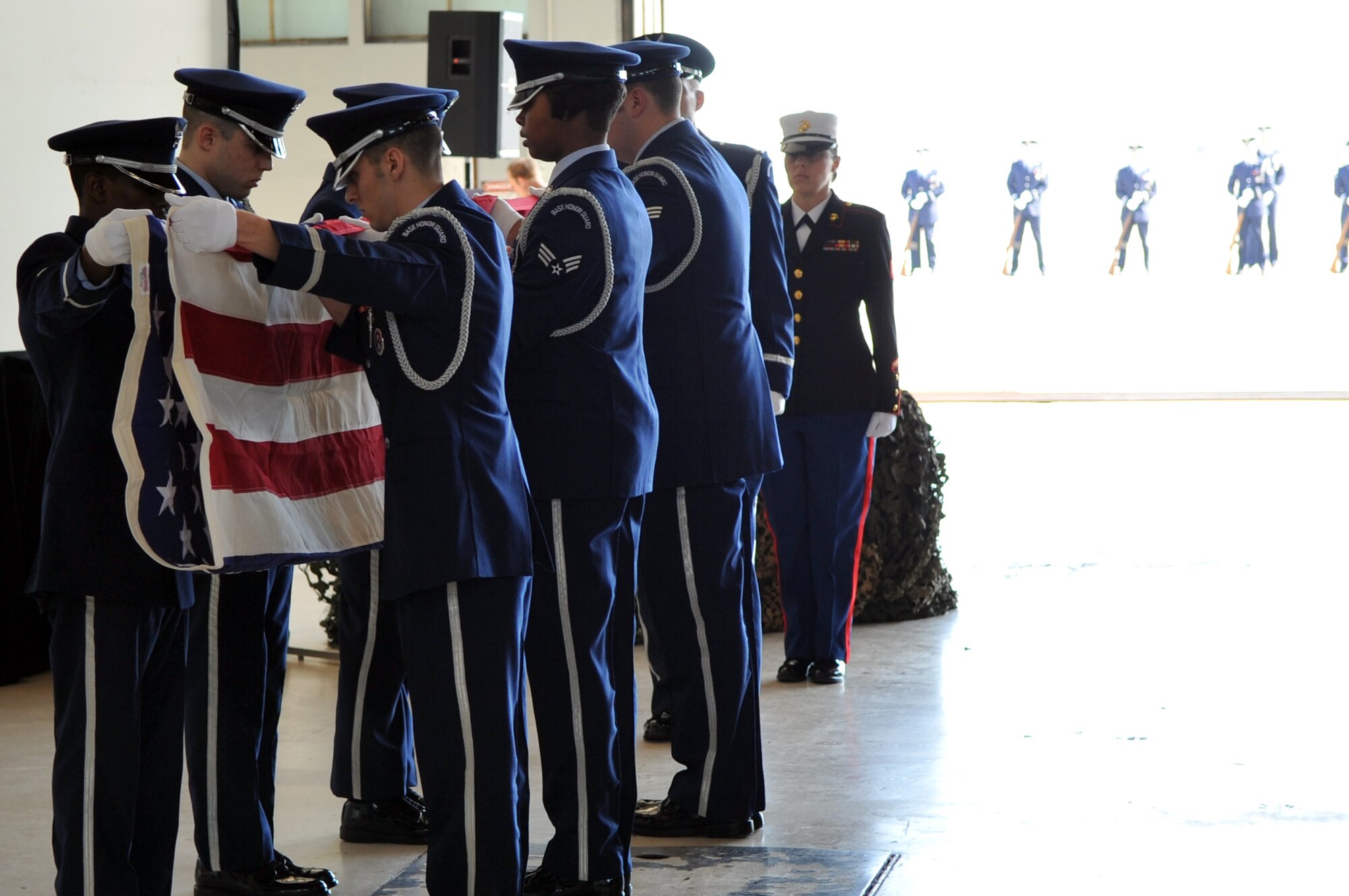 The Team Scott Honor Guard folds the American flag during a memorial service for Maj. Mark M. Binkowski Feb. 18. He was assigned to the Air Force Network Integration Center at Scott AFB, Ill., and passed away Feb. 12 from cancer. (Photo by Senior Airman Teresa Jennings)


