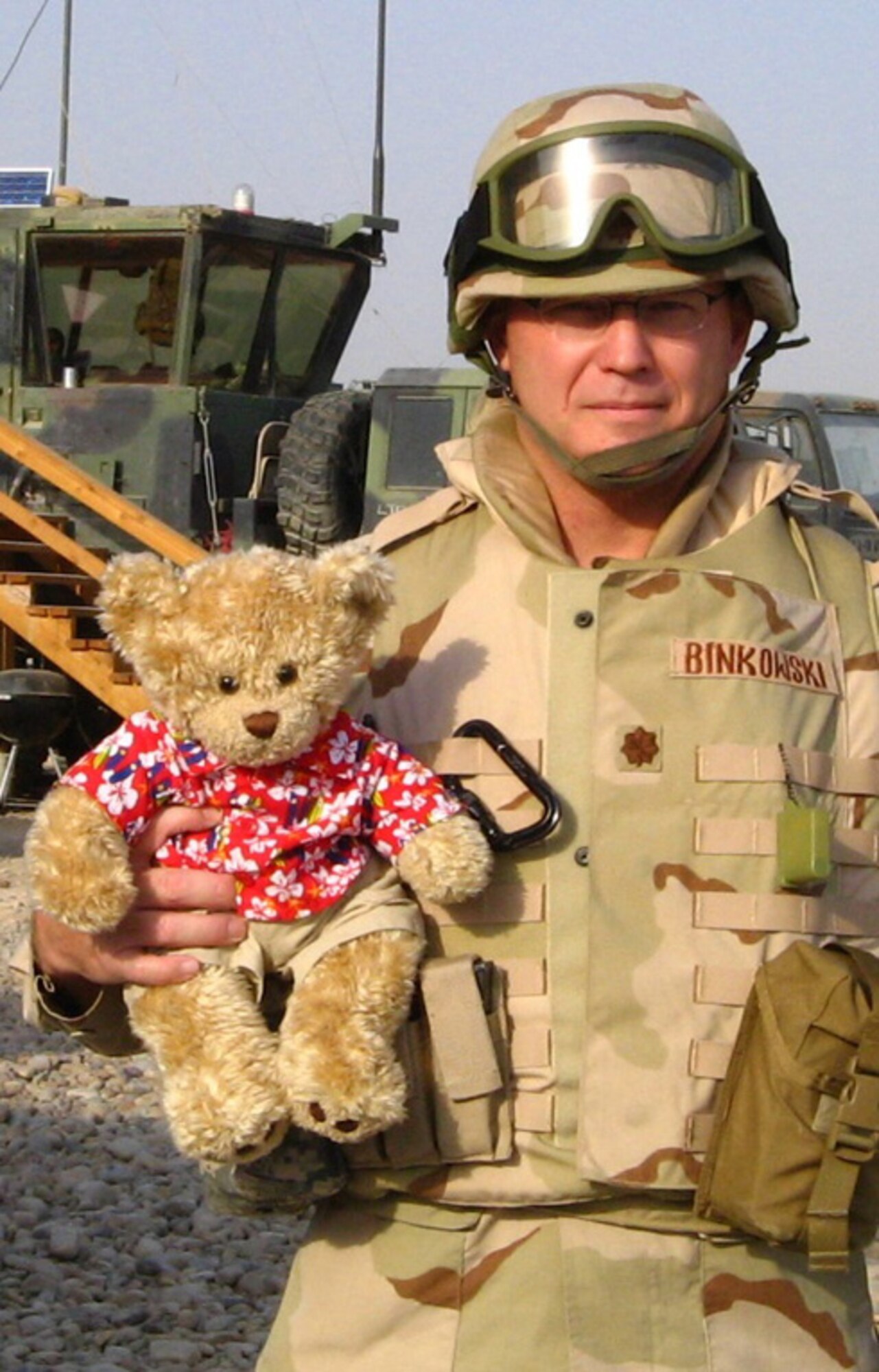 Maj. Mark Binkowski, who passed away Feb. 12 from cancer, is shown here as he holds a stuffed bear he brought with him on deployments to remind him of home. He was assigned to the Air Force Network Integration Center at Scott AFB, Ill., and a memorial service for him was held Feb. 18 at the base.