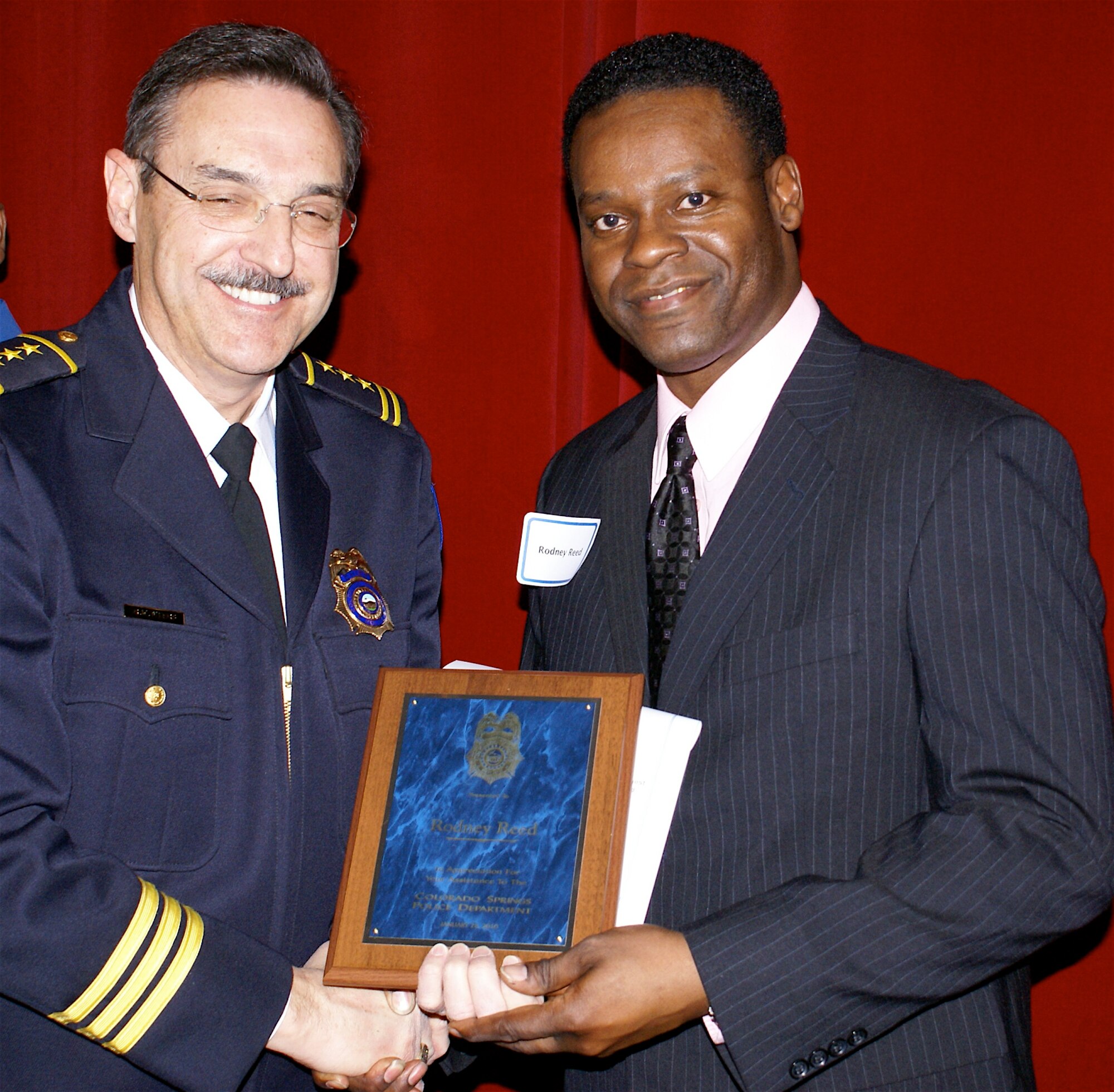 COLORADO SPRINGS, Colo. -- Master Sgt. Rodney Reed (right), received a Good Samaritan award Jan. 28 from Police Chief Richard Myers, Colorado Springs Police Department, at the CSPD’s annual awards ceremony. Sergeant Reed, 21st Space Wing Equal Opportunity Office, came to the aid of a teen-aged boy who had been struck by a vehicle and left in the busy intersection Oct. 17. (Colorado Springs Police Department photo/Bill Stanley)


