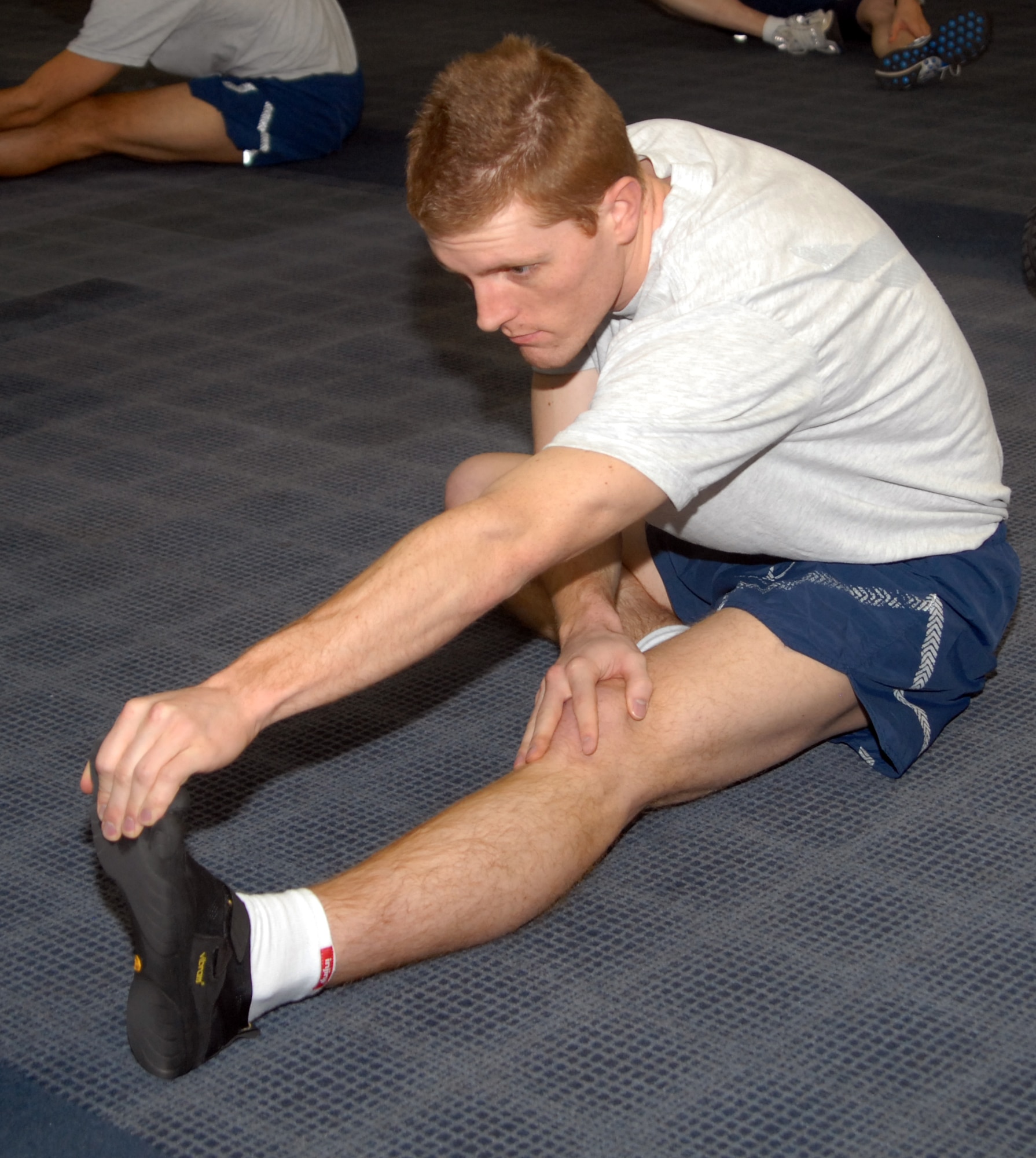 Staff Sgt. Ross Walline, Security Assistant/QAE, stretches before running Feb. 23 as part of the Air Reserve Personnel Center physical training program. (U.S. Air Force photo by Dwayne Beuthel.)