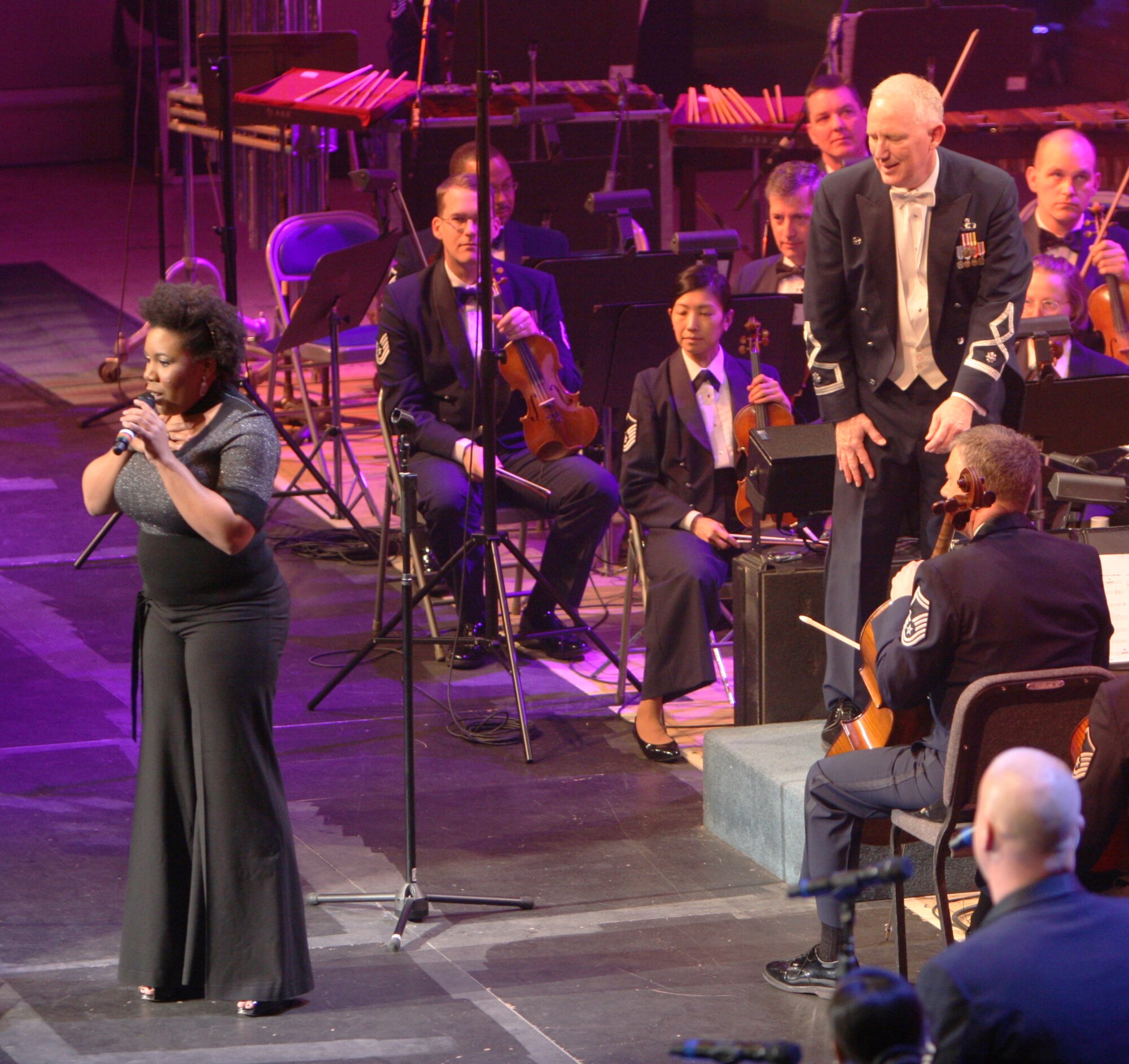 USAF Band Commander and Music Director Lt. Col. Alan Sierichs, pictured right, looks on as Melinda Doolittle, left, converses with a crowd of 1700 at the Daughters of the American Revolution Constitution Hall during the first concert of the USAF Band's guest artists series held Feb. 21. (USAF Photo by Benjamin Newell)