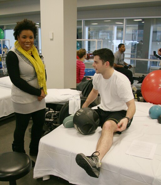 Top-3 American Idol finalist Melinda Doolittle Meets with Sgt. Jack Schumacher of the 25th Infantry Division, 4th Brigade, at Walter Reed Army Medical Center's Military Advanced Training Center. Wounded warriors are treated as tactical athletes at the MATC. Here, Ms. Doolittle is inroduced to how athletic training decreases recovery time and allows for more complete rehabilitation following serious injury. (USAF Photo by Benjamin Newell)