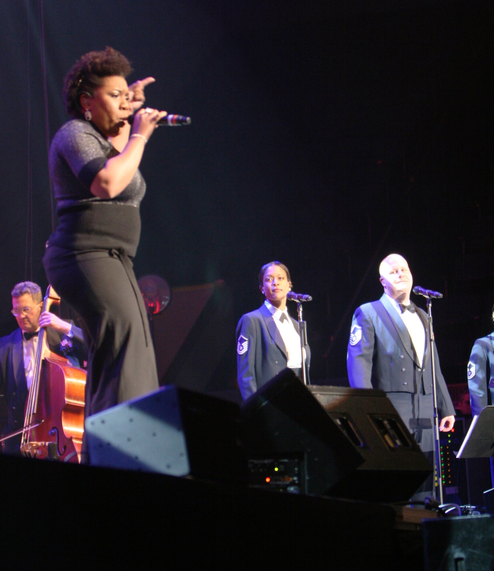 Top-3 American Idol finalist Melinda Doolittle opens up the USAF Band's guest artist series February 21, 2010 at the Daughters of the American Revolution Constitution Hall. Behind her, the Singing Sergeants act as backup singers to her soulful vocals. (USAF Photo by Benjamin Newell)