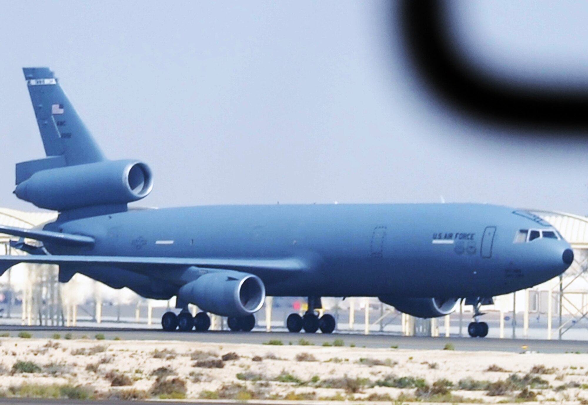 From athe window of an E-3 Sentry, a KC-10 Extender assigned to the 908th Expeditionary Air Refueling Squadron taxis down the flightline used by the 380th Air Expeditionary Wing at a non-disclosed base in Southwest Asia on Feb. 16, 2010.  In 2009, KC-10s from the 380th AEW and the 908th EARS flew 4,760 combat sorties offl-loading 422,222,300 pounds of fuel to 31,434 aircraft. In the same year, the KC-10s and their crews accumulated 40,011 hours of flight time. The 380th AEW supports operations Iraqi Freedom and Enduring Freedom and the Combined Joint Task Force-Horn of Africa. (U.S. Air Force Photo/Master Sgt. Scott T. Sturkol/Released)