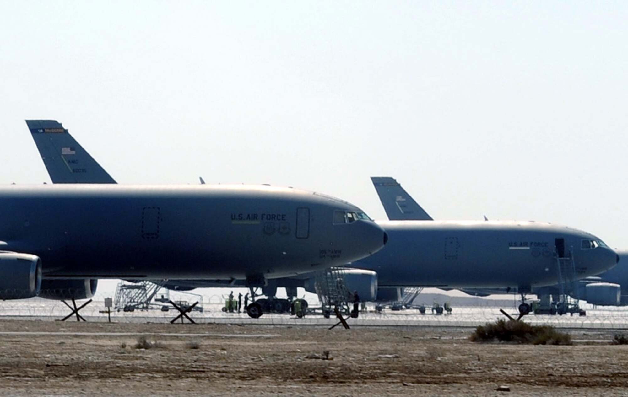 KC-10 Extenders assigned to the 908th Expeditionary Air Refueling Squadron are parked on the flightline used by the 380th Air Expeditionary Wing at a non-disclosed base in Southwest Asia on Feb. 16, 2010.  In 2009, KC-10s from the 380th AEW and the 908th EARS flew 4,760 combat sorties offl-loading 422,222,300 pounds of fuel to 31,434 aircraft. In the same year, the KC-10s and their crews accumulated 40,011 hours of flight time. (U.S. Air Force Photo/Master Sgt. Scott T. Sturkol/Released)