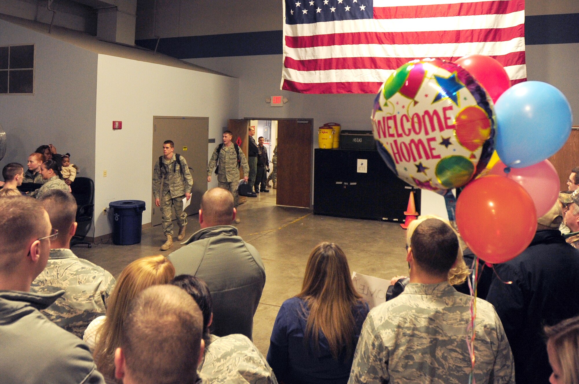 Friends and families await the arrival of their loved ones Feb. 23 from their deployment to Afghanistan. More than 150 Little Rock Airmen were welcomed home by loved ones from their deployment in support of operation Enduring Freedom. (U.S. Air Force photo by Senior Airman Steele C. G. Britton)