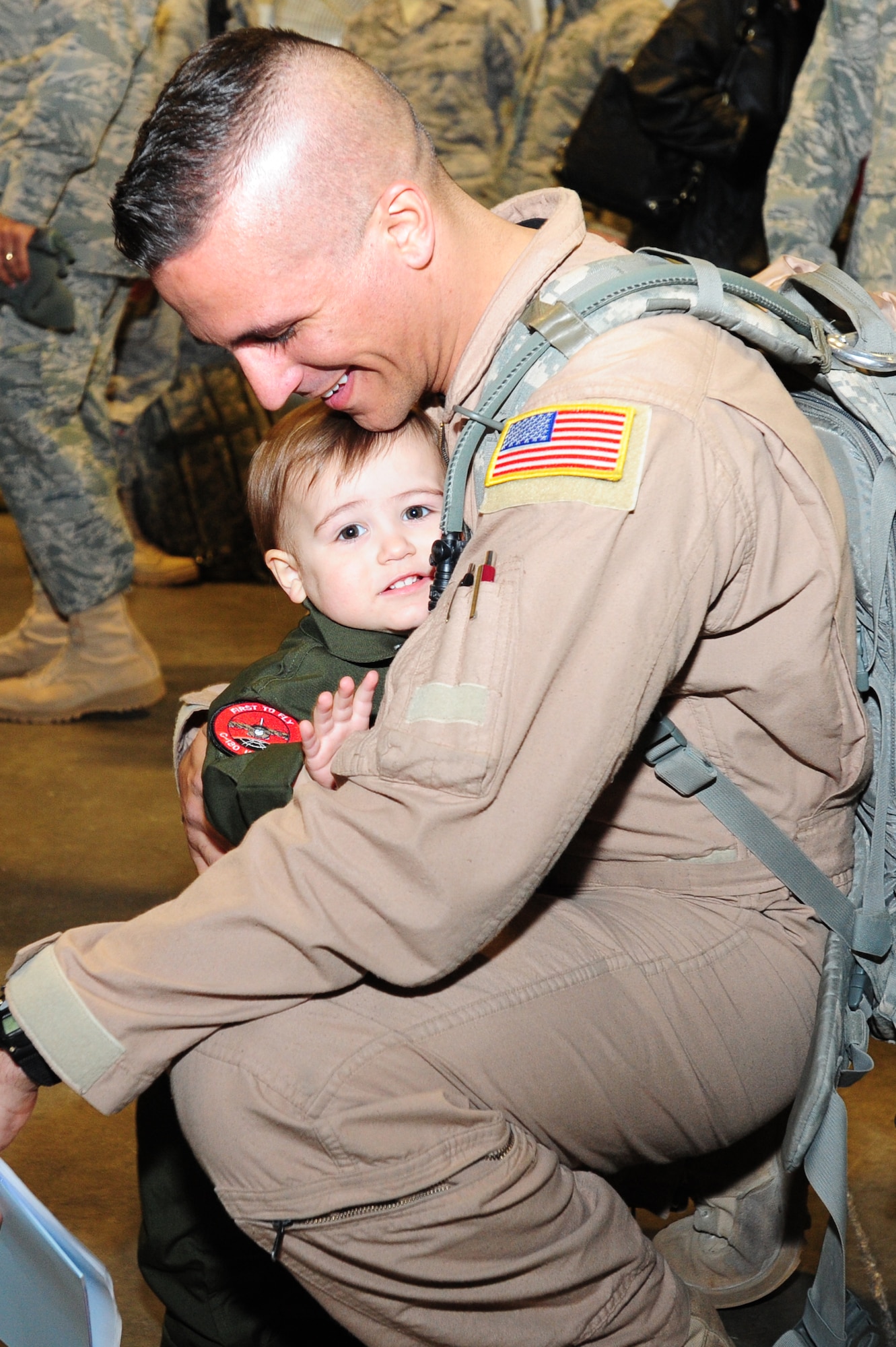 Staff Sgt. Gabe Campbell, 41st Airlift Squadron loadmaster, hugs his 18-month old son, Ari, upon his return Feb. 23 from his deployment to Afghanistan. More than 150 Little Rock Airmen were welcomed home by loved ones from their deployment in support of operation Enduring Freedom.  (U.S. Air Force photo by Senior Airman Steele C. G. Britton)