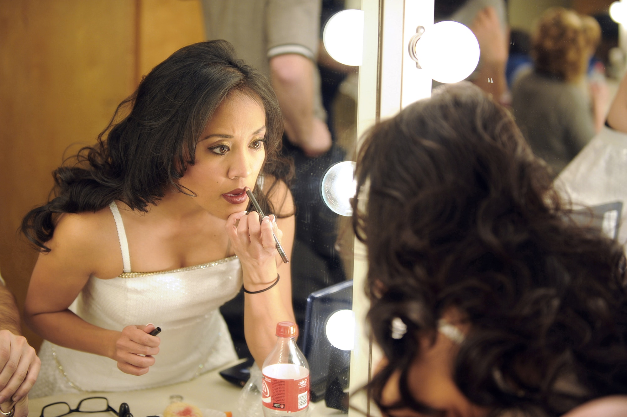 Senior Airman Jennifer Bone applies makeup before a performance at the Patriot Hall Auditorium Feb. 3, 2010, in Sumter, S.C. Airman Bone is a member of Tops In Blue. (U.S. Air Force photo/Airman 1st Class Neil D. Warner)