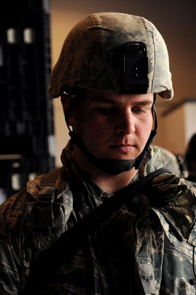 MOODY AIR FORCE BASE, Ga. -- Airman 1st Class Zach Schott, 823rd Security Forces Squadron member, waits as other Airmen fill out paperwork in a personnel deployment function processing line during a Phase I Operational Readiness Exercise here Feb. 22. Personnel are required to process through the PDF line to ensure they are cleared and ready for their deployment. (U.S. Air Force photo by Airman 1st Class Joshua Green)
