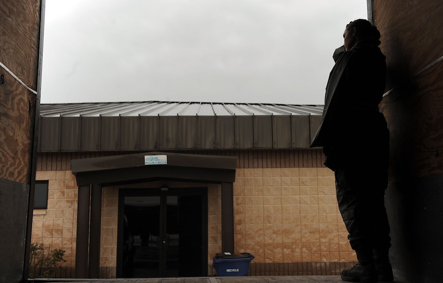 MOODY AIR FORCE BASE, Ga. -- Airman 1st Class Shelby Goss, 23rd Contracting Squadron contracting specialist, wipes the rain from her hair as she waits for mobility bags to load onto a truck during a Phase I Operational Readiness Exercise here Feb. 22. Once the mobility bags are received, they are palletized and loaded onto to an aircraft. (U.S. Air Force photo by Airman 1st Class Joshua Green)
