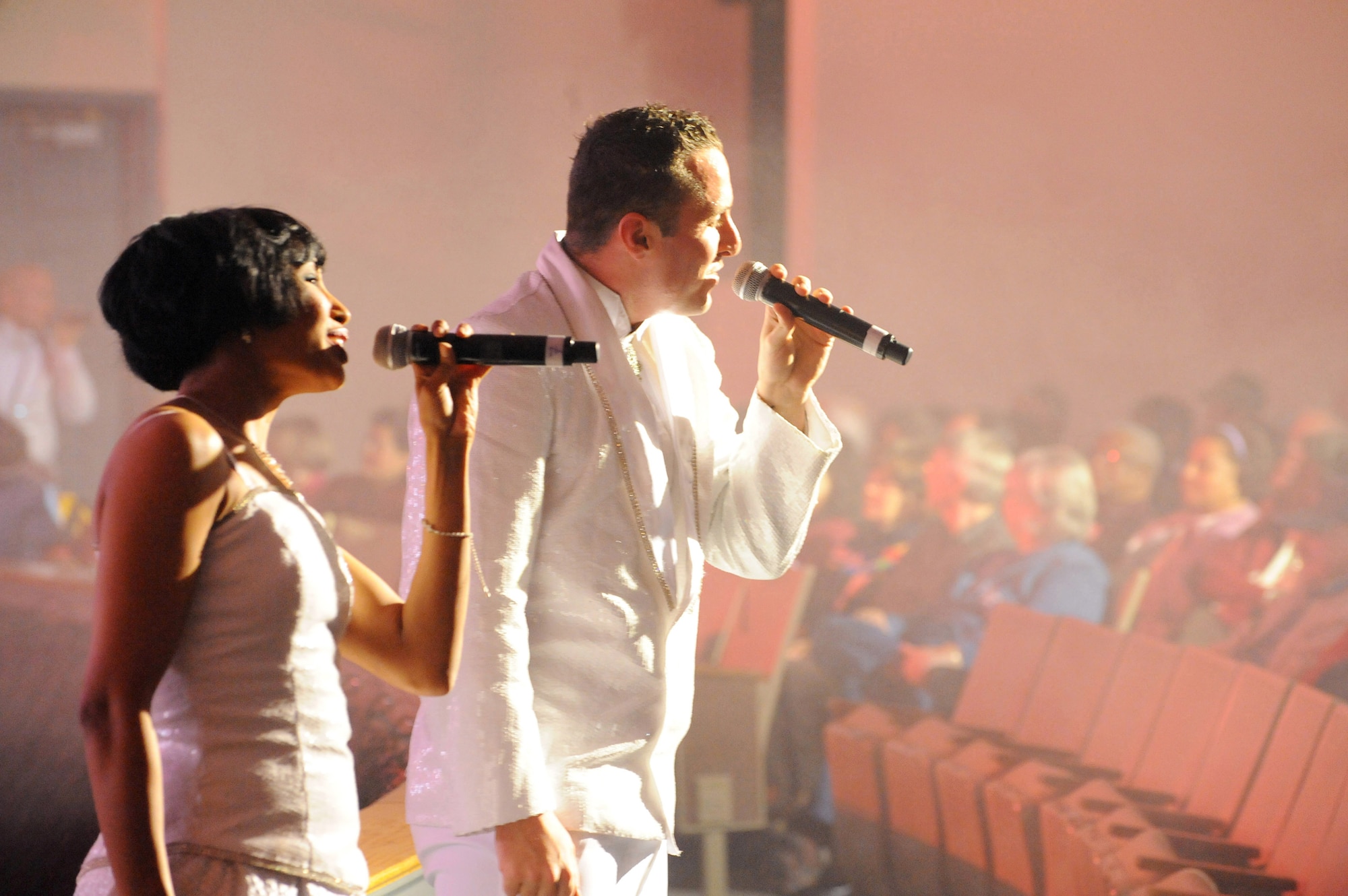 Staff Sgt. Aisha Smith (left) and Senior Airman Johnny Magbanua sing during a performance at the Patriot Hall Auditorium Feb. 3, 2010, in Sumter, S.C. Sergeant Smith and Airman Magbanua are members of Tops In Blue. (U.S. Air Force photo/Airman 1st Class Neil D. Warner)
