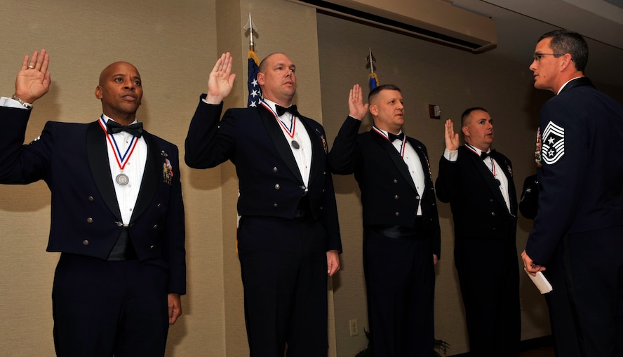 MOODY AIR FORCE BASE, Ga. -- (Right) Chief Master Sgt. Richard Parsons, 23rd Wing command chief, administers the Chief’s oath to the newest chief master sergeant selectees during the Chief’s Recognition Ceremony here Feb. 20. The chief master sergeants who were inducted Dec. 1, 1959, forged a new path and set the foundation for chiefs of the 21st century. The history of the chief master sergeant is built upon the ranks of brave enlisted professionals. (U.S. Air Force photo by Staff Sgt. Schelli Jones)
