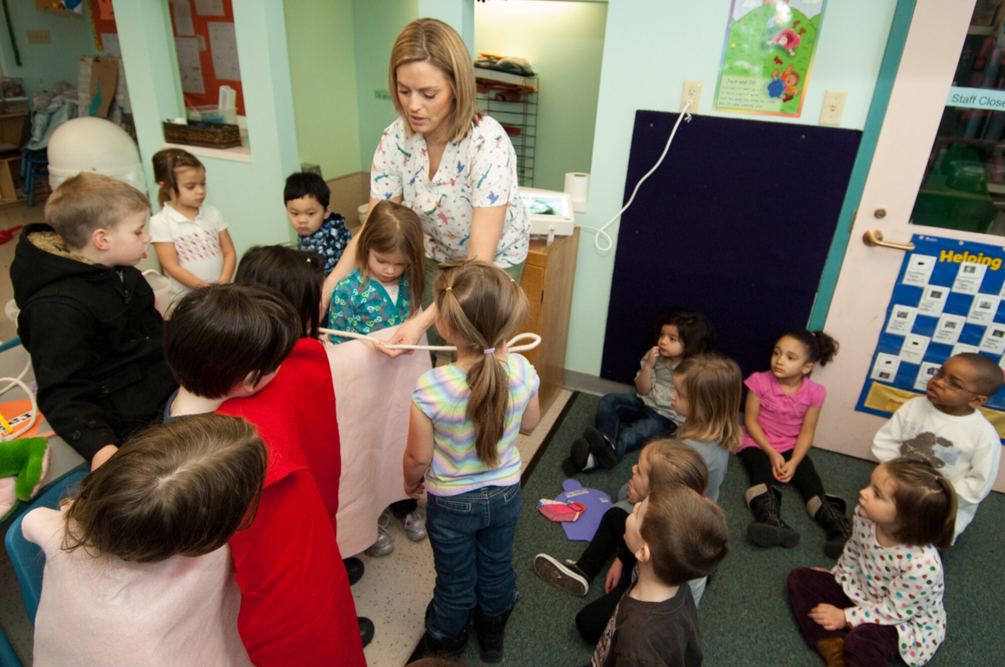 HANSCOM AIR FORCE BASE, Mass. – As part of National Children’s Dental Health Month, Staff Sgt. Kristin Hays, 66th Dental Flight dental hygienist, gives a flossing demonstration for children during a visit to the Child Development Center. Throughout February, Dental Flight staff members have reached out to Hanscom’s children to promote the importance of good dental hygiene.  (U.S. Air Force photo by Rick Berry)