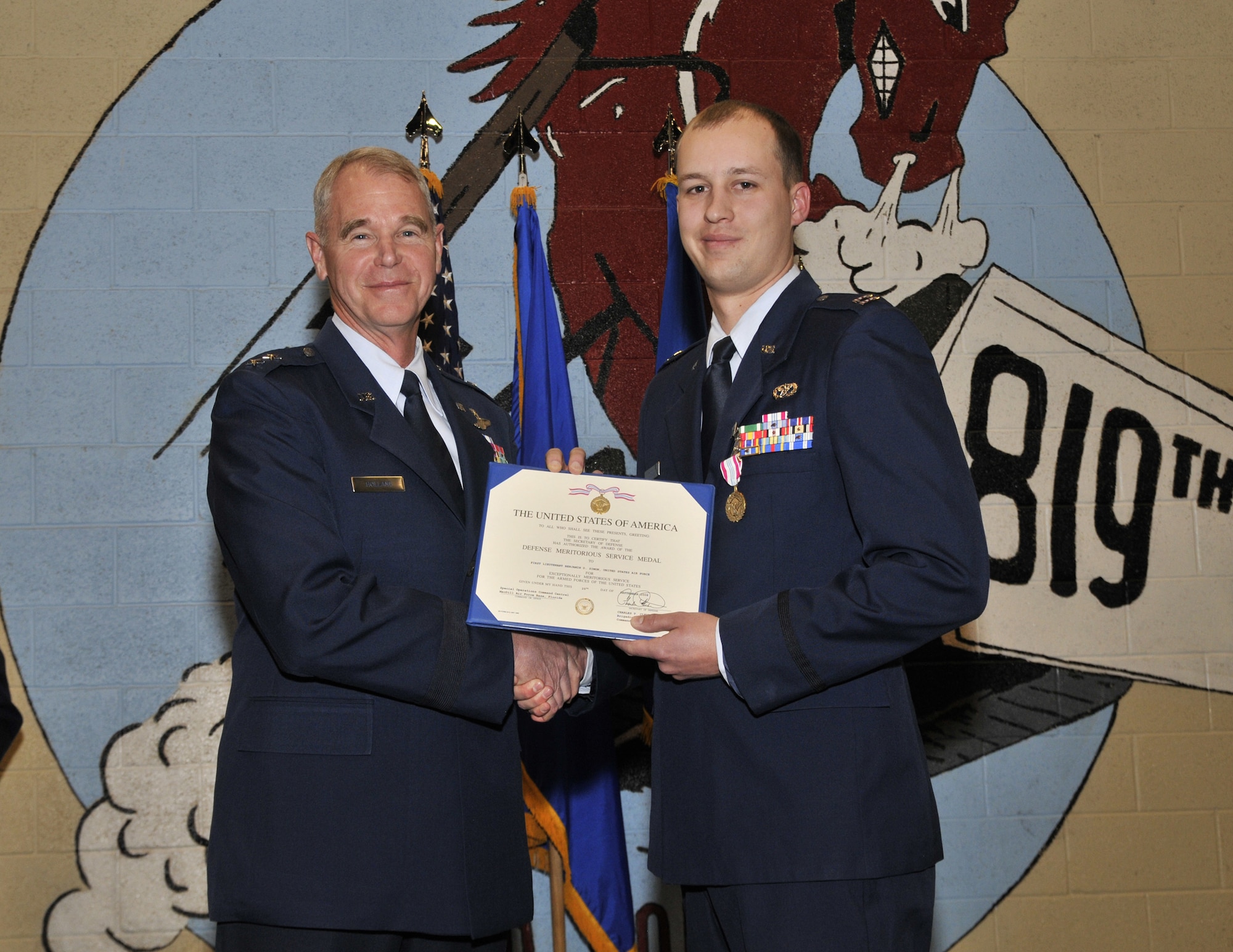 Capt. Benjamin Simon shakes hands with Maj. Gen. William Holland after the 9th Air Force commander presented him with the Defense Meritorious Service Medal Jan. 29 at a ceremony at Malmstrom. (U.S. Air Force photo/John Turner)
