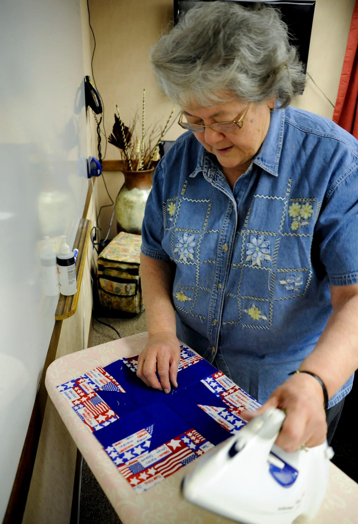 Amy Armenta irons a star-patterned quilt at the Airmen Family Readiness Center at Cannon Air Force Base, N.M., Feb. 19. She is a member of Operation Home Front Quilts, an organization that sends quilts to families of fallen servicemembers. Since April 2004, Cannon's group has made and donated nearly 600 quilts. (U.S. Air Force photo/ Senior Airman Cardenas)