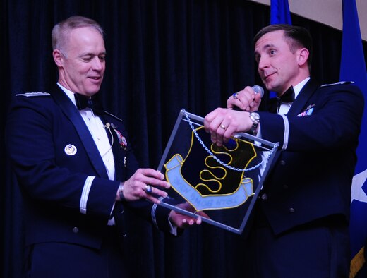 ELLSWORTH AIR FORCE BASE, S.D. -- Lt. Gen. Dick Newton III, deputy chief of staff for manpower and personnel, Headquarters, U.S. Air Force, Washington D.C., accepts a stained glass logo of the 28th Bomb Wing from Col. Jeffrey Taliaferro, 28 BW commander , Feb. 20.  General Newton was the guest speaker during the 28 BW Winter Formal. (U.S. Air Force photo/Airman 1st Class Anthony Sanchelli)