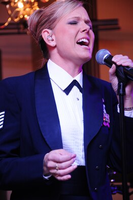 ELLSWORTH AIR FORCE BASE, S.D. -- Tech. Sgt. Lara Murdzia, NCO-in charge and lead vocalist for the U.S. Air Force Heartland of America Band "Night Wing," sings "Sweet Child of Mine" during the 28th Bomb Wing Winter Formal, Feb. 20.  Night Wing has shared the stage with singers Neil McCoy, Jo Dee Messina, Jollie Edwards, Jessica Andrews and the Beach Boys, among others. (U.S. Air Force photo/Airman 1st Class Anthony Sanchelli)
