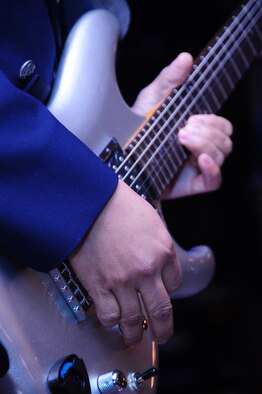 ELLSWORTH AIR FORCE BASE, S.D. -- Senior Airman Daniel Santos, lead guitarist for the U.S. Air Force Heartland of America Band "Night Wing," starts off the night with "Sweet Child of Mine," originally performed by "Guns-n-Roses," during the 28th Bomb Wing Winter Formal, Feb. 20.  Their music stretches from the top 40 pop and country hits of today to popular rock' n' roll classics. (U.S. Air Force photo/Airman 1st Class Anthony Sanchelli)
