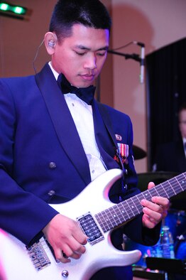 ELLSWORTH AIR FORCE BASE, S.D. -- Senior Airman Daniel Santos, lead guitarist for the U.S. Air Force Heartland of America Band "Night Wing," starts off the night with "Sweet Child of Mine," originally performed by "Guns-n-Roses," during the 28th Bomb Wing Winter Formal, Feb. 20.  Their music stretches from the top 40 pop and country hits of today to popular rock' n' roll classics. (U.S. Air Force photo/Airman 1st Class Anthony Sanchelli)